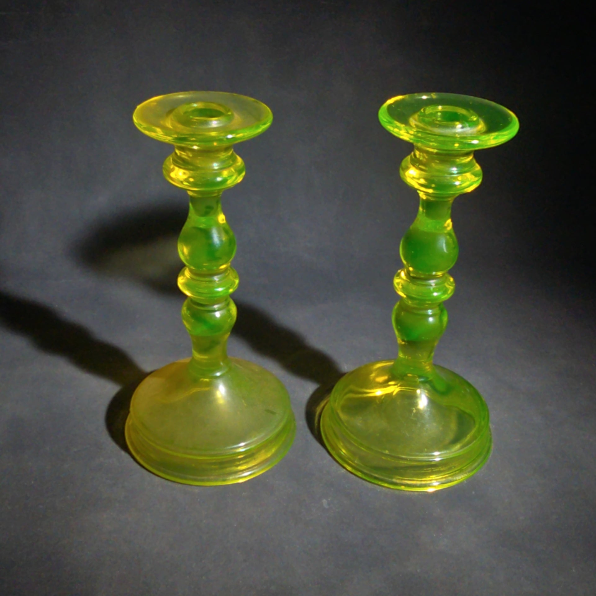 Pair of Antique Uranium Glass Candlesticks with Baluster Stems and Round Bases, UV Reactive