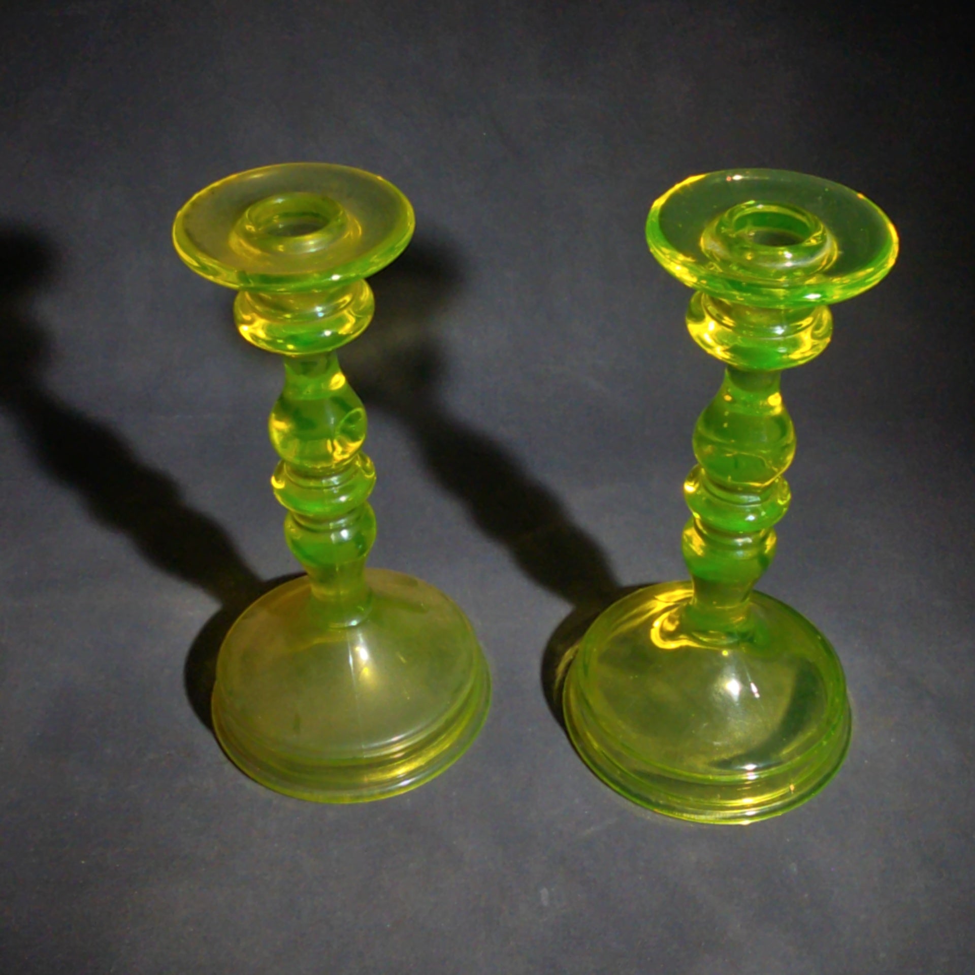 Pair of Antique Uranium Glass Candlesticks with Baluster Stems and Round Bases, UV Reactive
