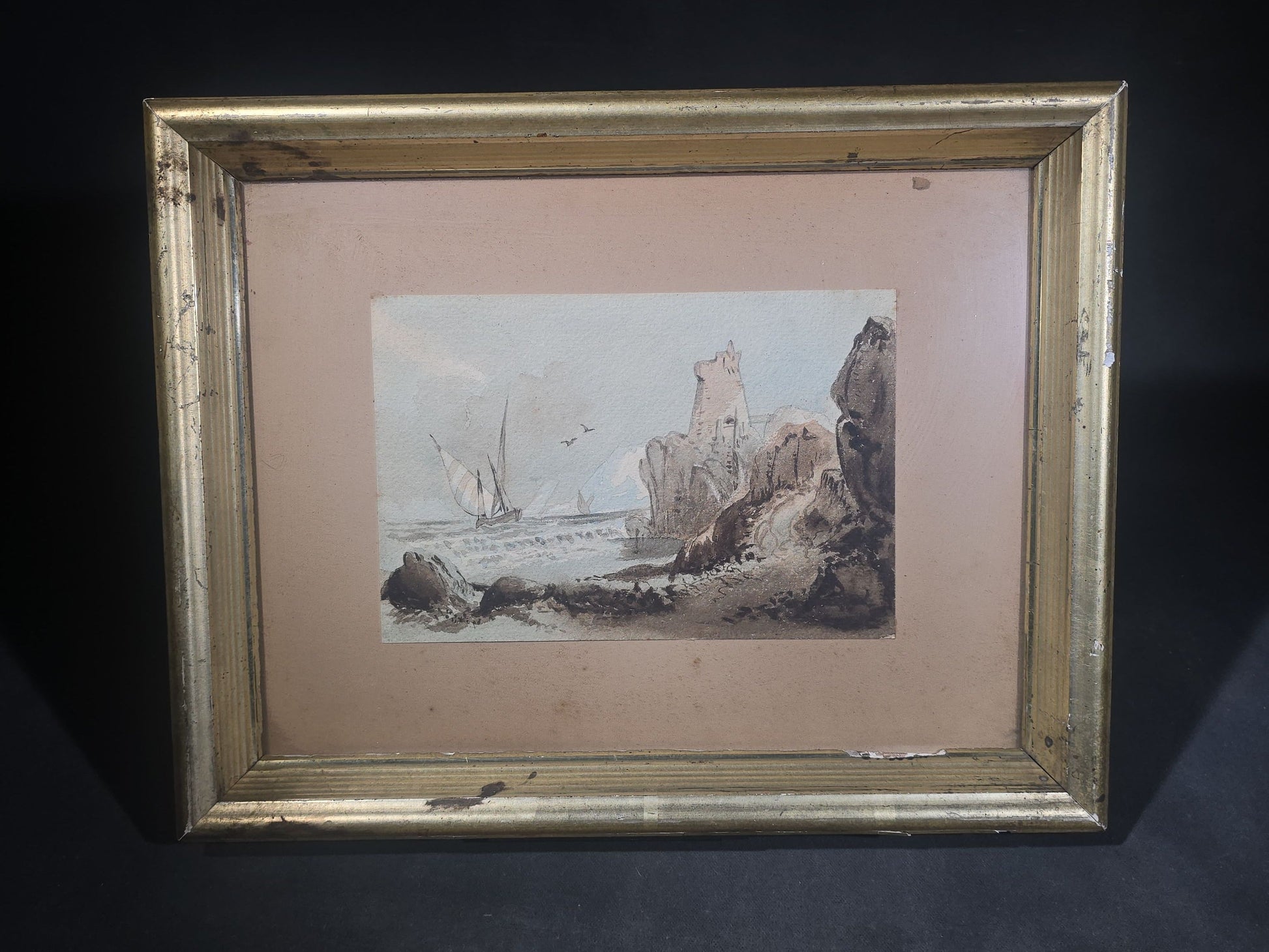 Antique Watercolor Painting on Paper, Coastal Scene with Rocky Cliffs, Tower Ruin, and Sailing Vessels, in Gilt Wood Frame