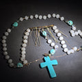 Lot 083 - Vintage Beaded Rosary Necklace with Turquoise Skull Beads, Cross Pendant, and Gold-Plated Fringe Elements