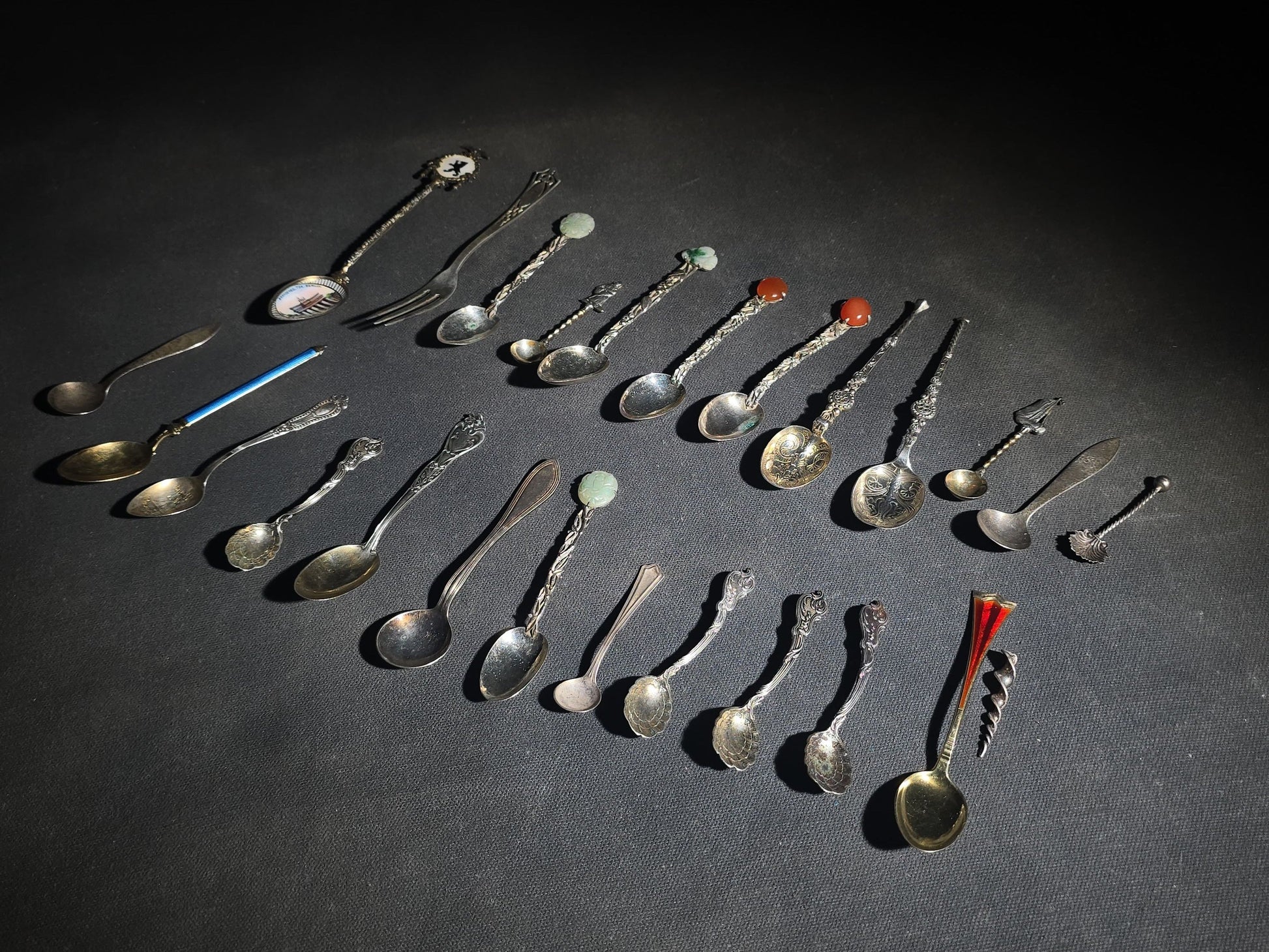 Grouping of 24 Antique and Vintage Sterling, 800 Silver, and Silver-Plated Souvenir and Collector's Spoons and Cutlery including 23 Spoons and One Fork