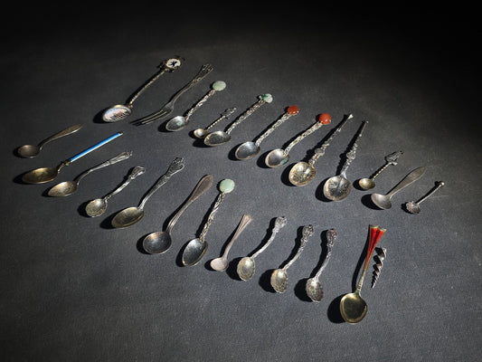 Grouping of 24 Antique and Vintage Sterling, 800 Silver, and Silver-Plated Souvenir and Collector's Spoons and Cutlery including 23 Spoons and One Fork