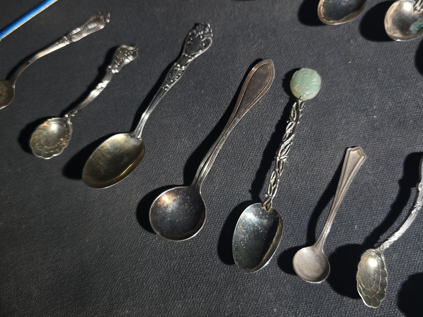 Grouping of 24 Antique and Vintage Sterling, 800 Silver, and Silver-Plated Souvenir and Collector's Spoons and Cutlery including 23 Spoons and One Fork