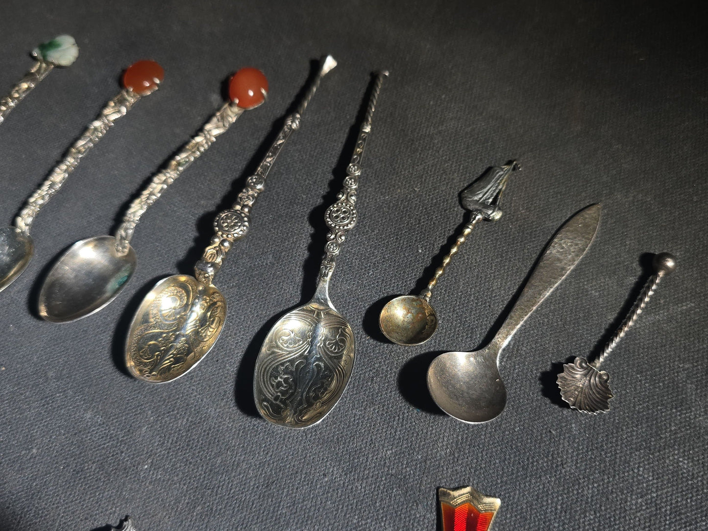 Grouping of 24 Antique and Vintage Sterling, 800 Silver, and Silver-Plated Souvenir and Collector's Spoons and Cutlery including 23 Spoons and One Fork