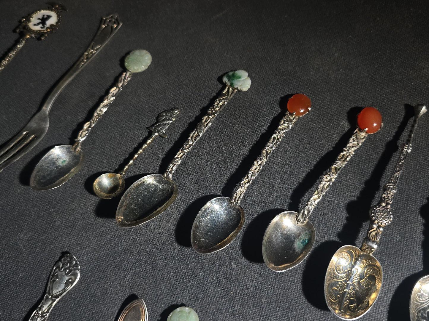 Grouping of 24 Antique and Vintage Sterling, 800 Silver, and Silver-Plated Souvenir and Collector's Spoons and Cutlery including 23 Spoons and One Fork