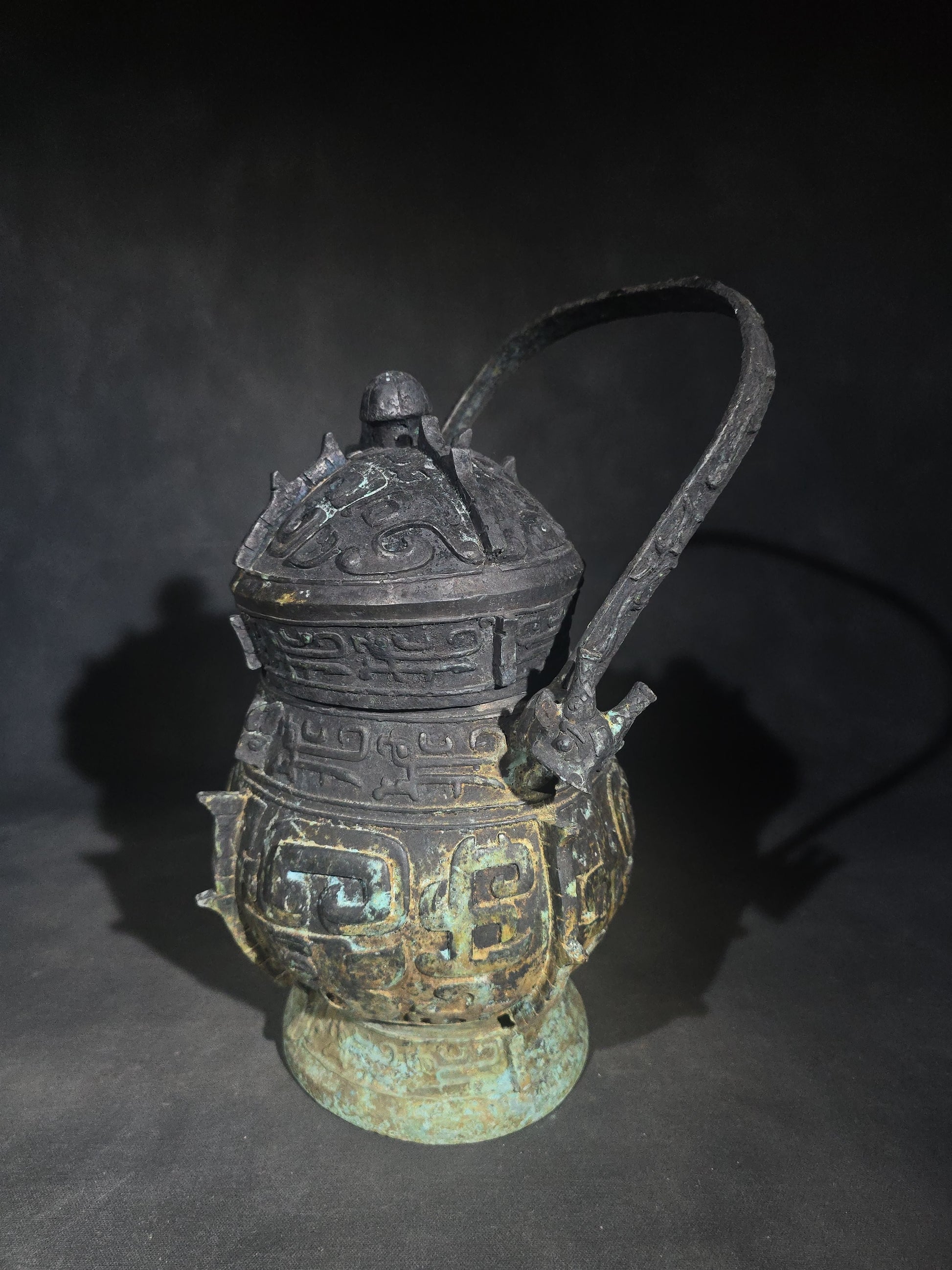 Antique Chinese Bronze You Vessel Reproduction with Taotie Mask Decoration, Swing Bail Handle, and Lidded Top
