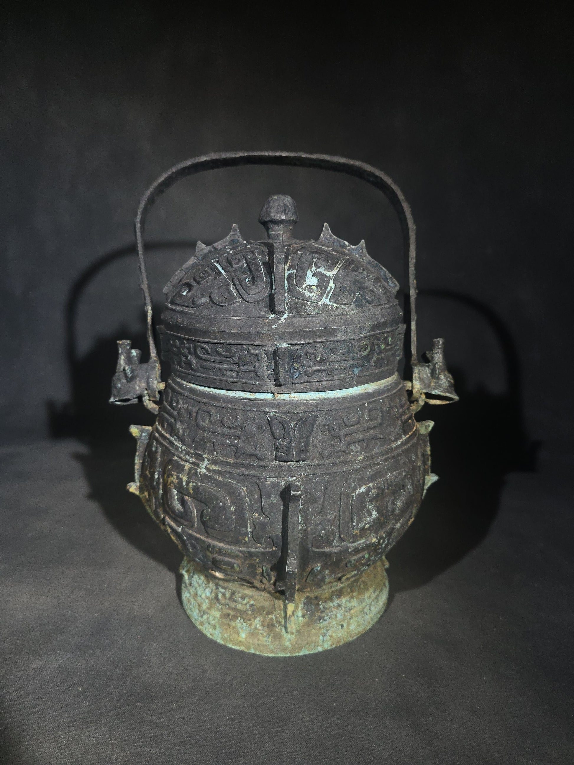 Antique Chinese Bronze You Vessel Reproduction with Taotie Mask Decoration, Swing Bail Handle, and Lidded Top