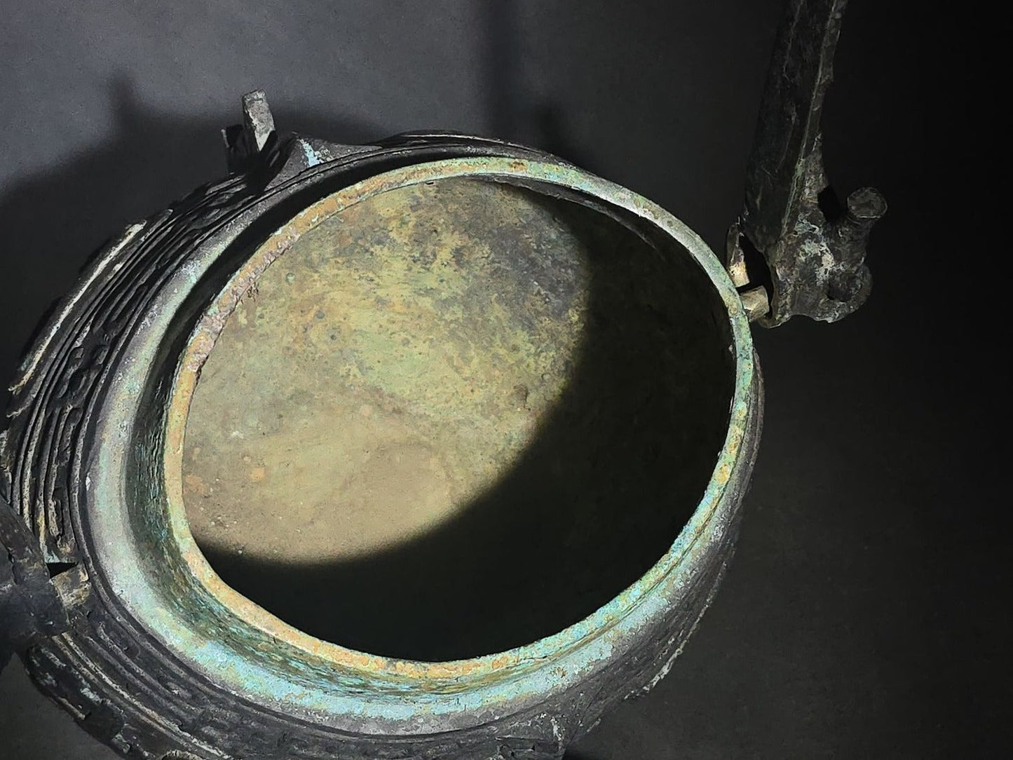 Antique Chinese Bronze You Vessel Reproduction with Taotie Mask Decoration, Swing Bail Handle, and Lidded Top