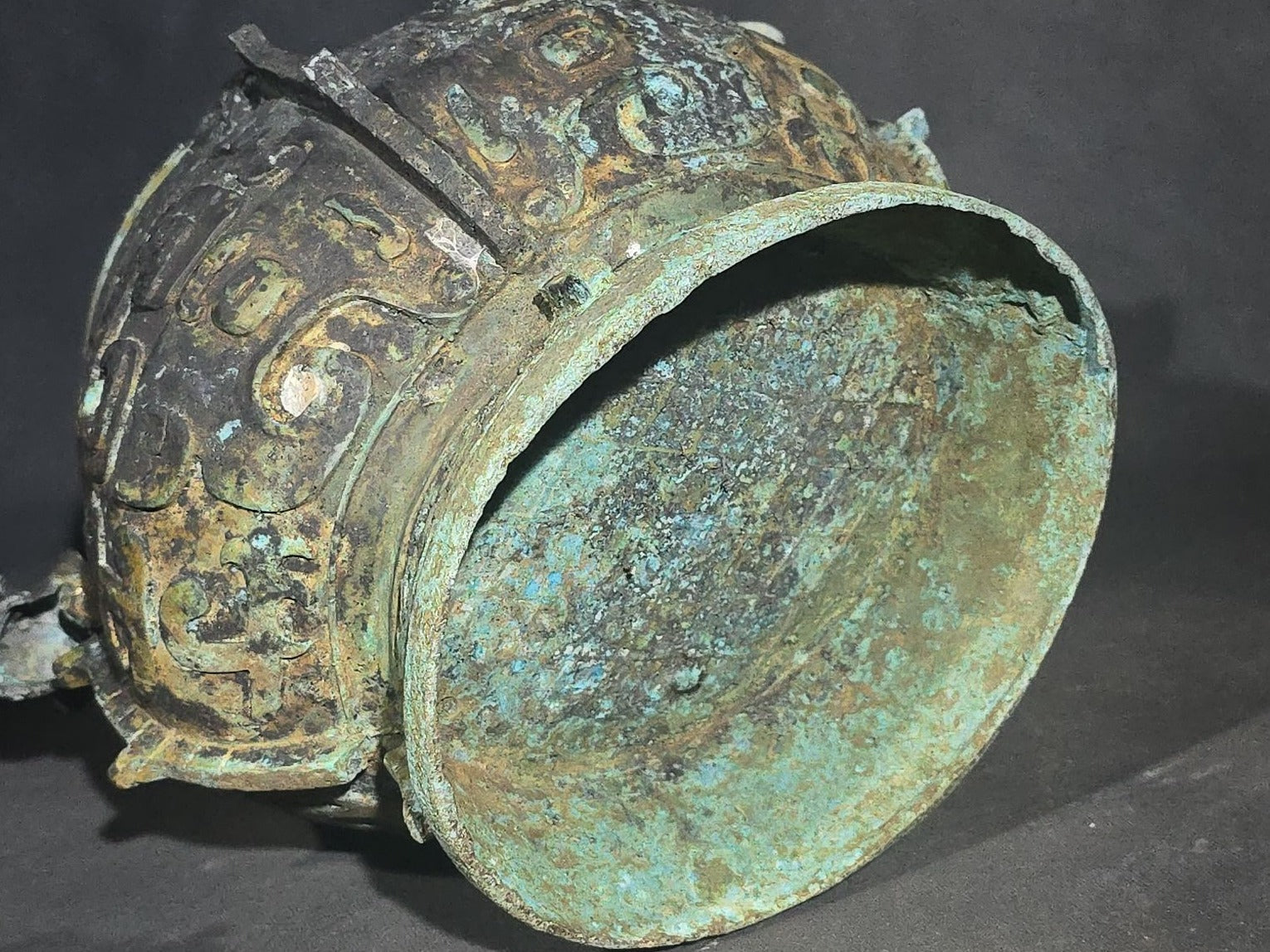 Antique Chinese Bronze You Vessel Reproduction with Taotie Mask Decoration, Swing Bail Handle, and Lidded Top