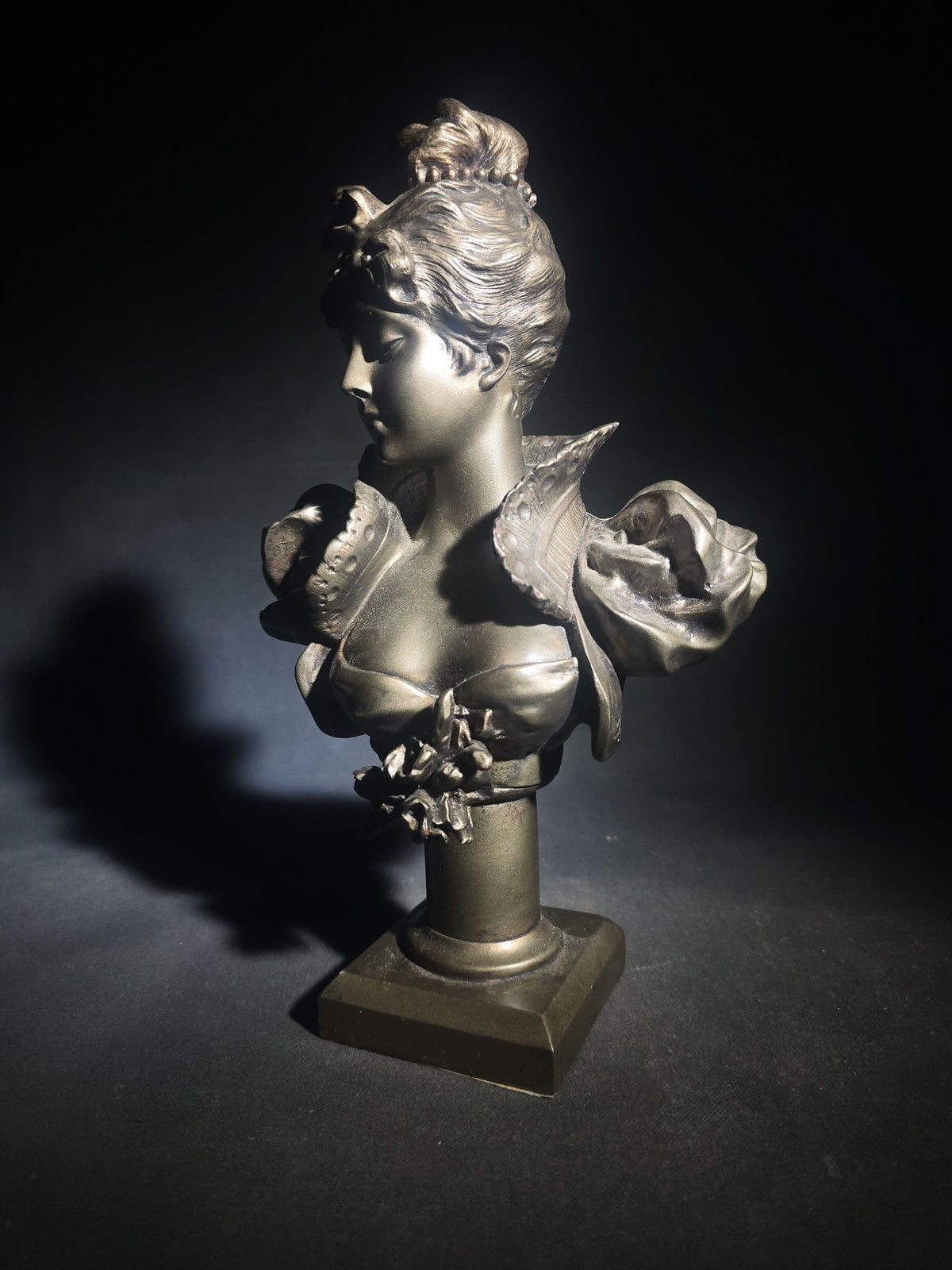 Vintage Art Nouveau Style Bust of a Young Woman with Upswept Hair, Ruffled Collar, and Rose Spray on Pedestal Base