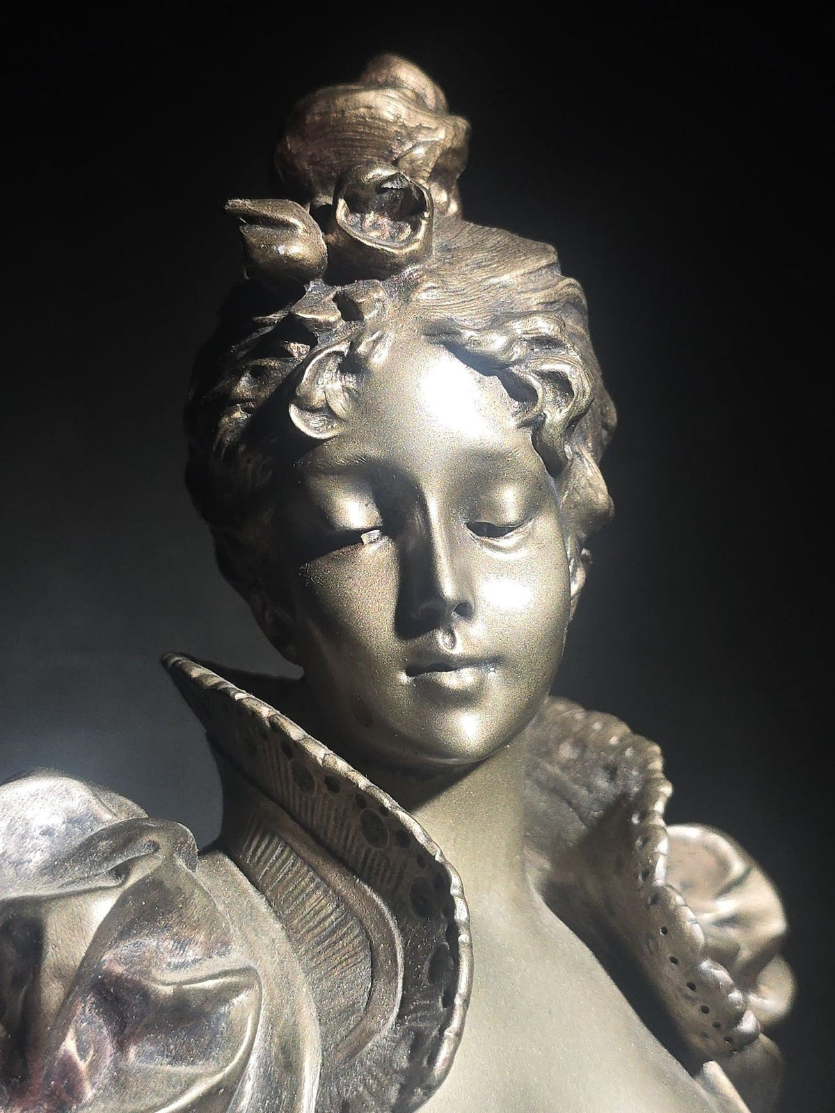 Vintage Art Nouveau Style Bust of a Young Woman with Upswept Hair, Ruffled Collar, and Rose Spray on Pedestal Base