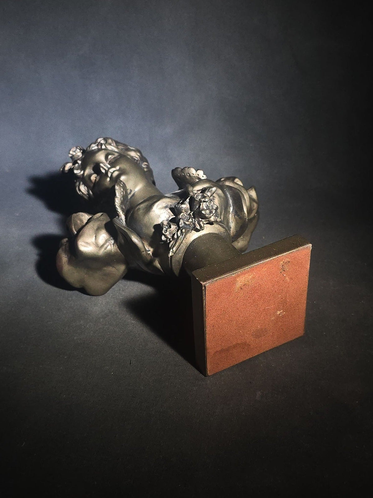 Vintage Art Nouveau Style Bust of a Young Woman with Upswept Hair, Ruffled Collar, and Rose Spray on Pedestal Base