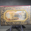 Lot 073 - Antique Etched Metal Aide-Memoire Pocket Notebook with Hand-Painted Landscape Scene, Gold Scroll Decoration, and Figural Back Cover with Pencil, 3-3/8" H