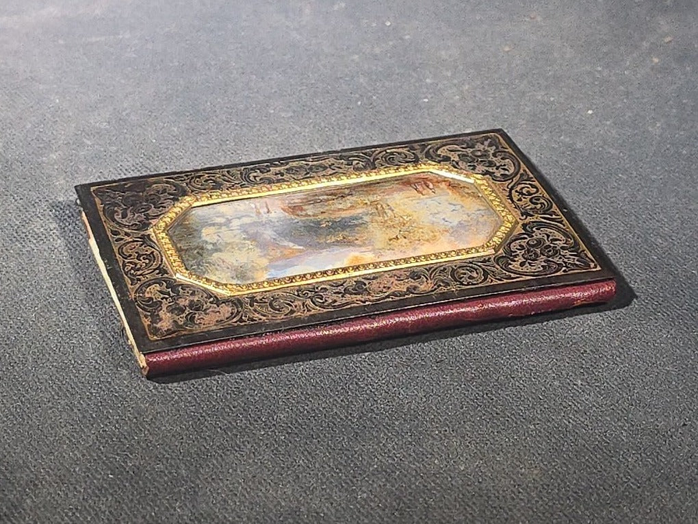 Antique Etched Metal Aide-Memoire Pocket Notebook with Hand-Painted Landscape Scene, Gold Scroll Decoration, and Figural Back Cover with Pencil