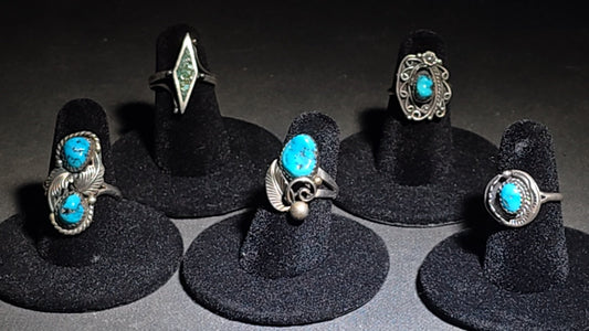 Grouping of Five Vintage Southwestern Unmarked Sterling Silver and Turquoise Rings including Two-Stone Leaf, Crushed Turquoise Diamond, Scrollwork Oval, Leaf and Scroll, and Circular Surround
