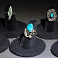Lot 037 - Grouping of Five Vintage Southwestern Unmarked Sterling Silver and Turquoise Rings Including Two-Stone Leaf, Crushed Turquoise Diamond, Scrollwork Oval, Leaf and Scroll, and Circular Surround, Total Weight 18.79 g