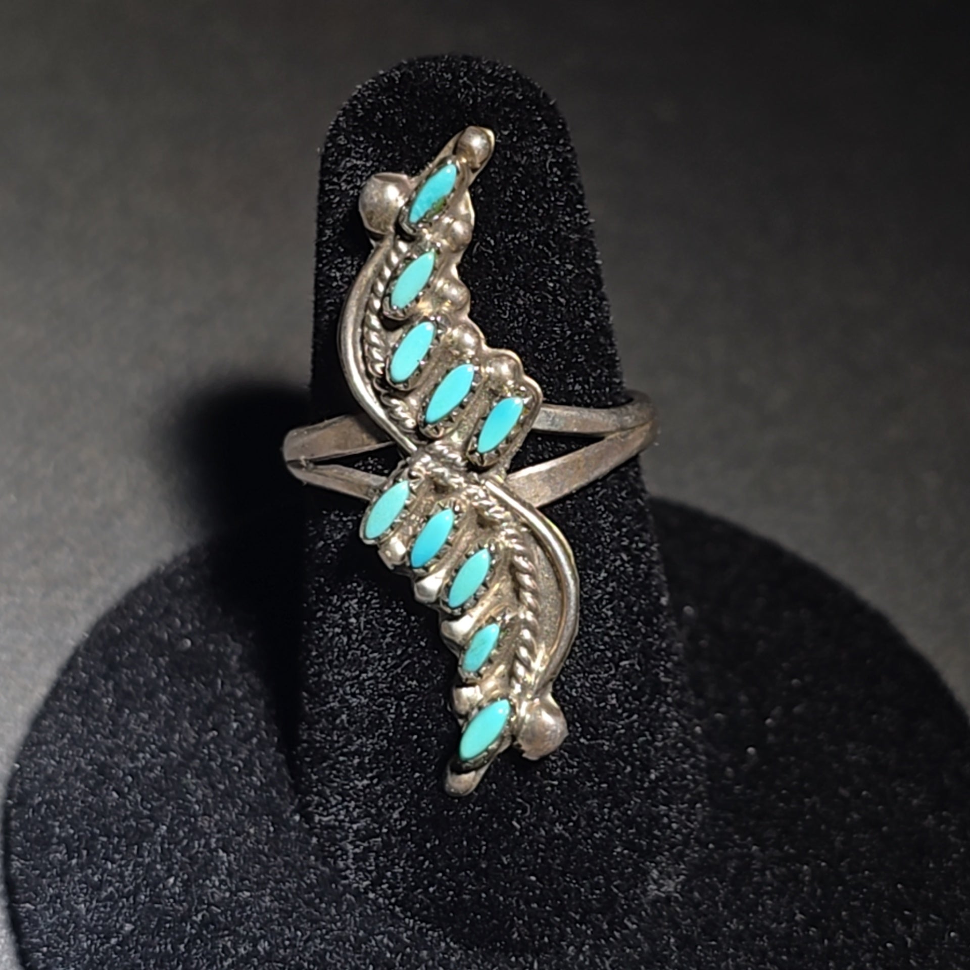 Grouping of Four Vintage Southwestern Sterling Silver and Turquoise Rings including Three Matching Petit Point Leaf Rings and a Three-Stone Oval Cabochon Ring