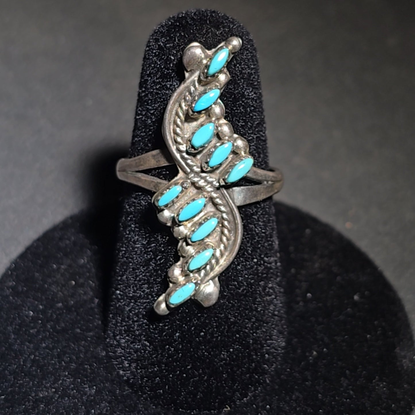 Grouping of Four Vintage Southwestern Sterling Silver and Turquoise Rings including Three Matching Petit Point Leaf Rings and a Three-Stone Oval Cabochon Ring