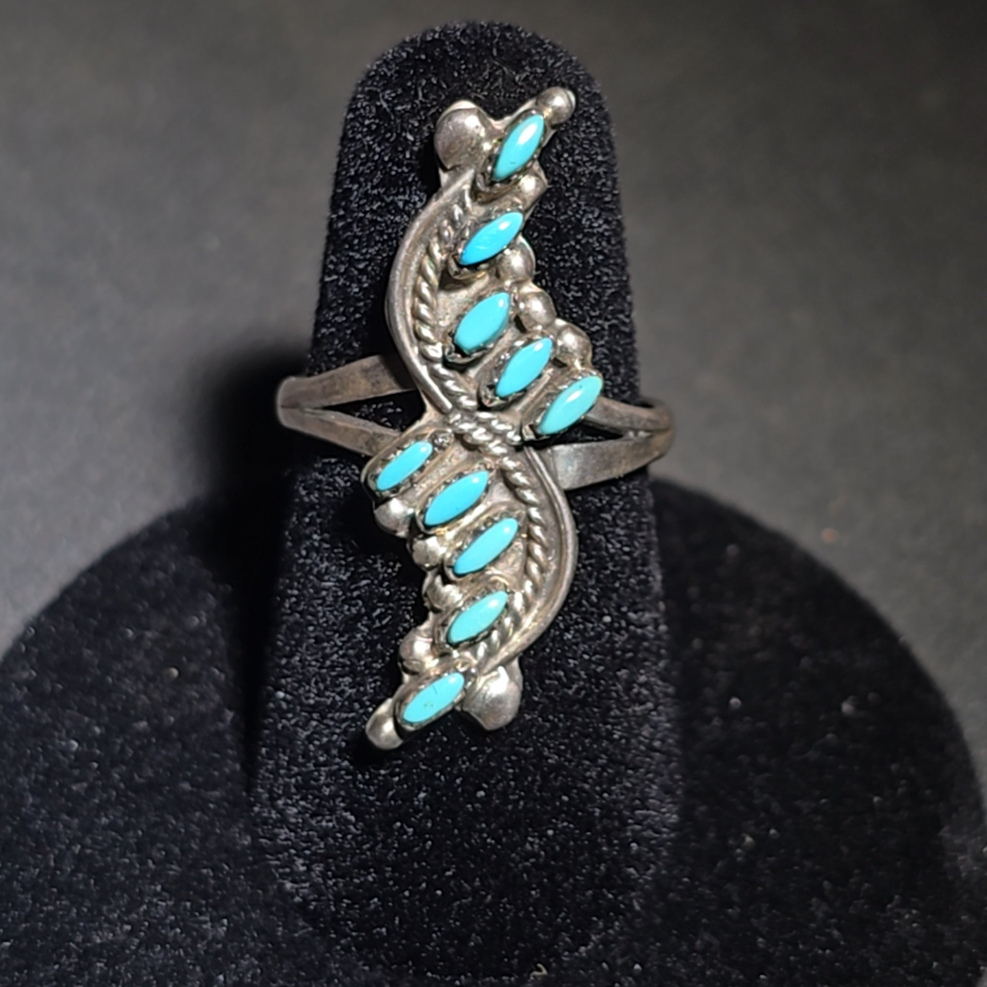Grouping of Four Vintage Southwestern Sterling Silver and Turquoise Rings including Three Matching Petit Point Leaf Rings and a Three-Stone Oval Cabochon Ring