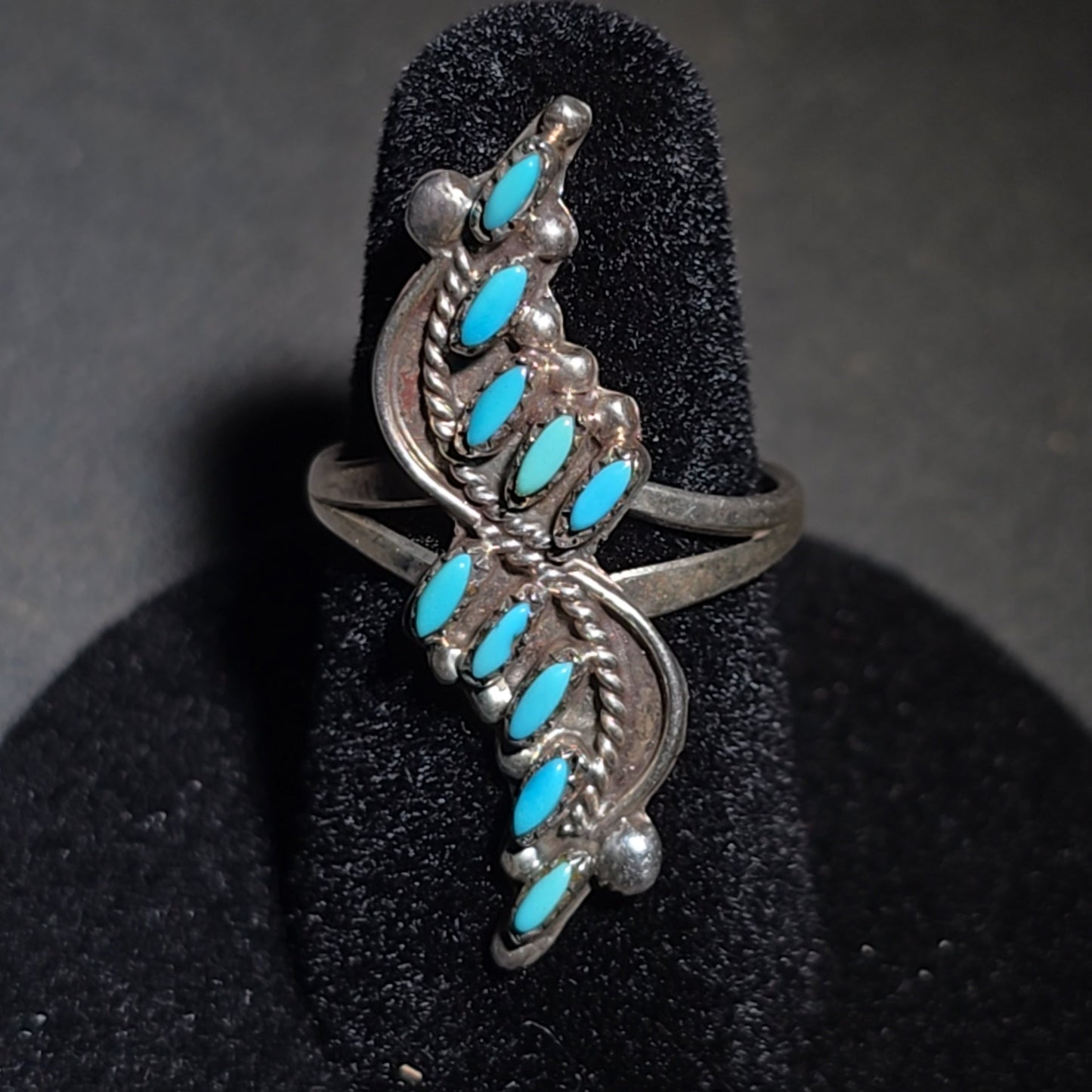 Grouping of Four Vintage Southwestern Sterling Silver and Turquoise Rings including Three Matching Petit Point Leaf Rings and a Three-Stone Oval Cabochon Ring