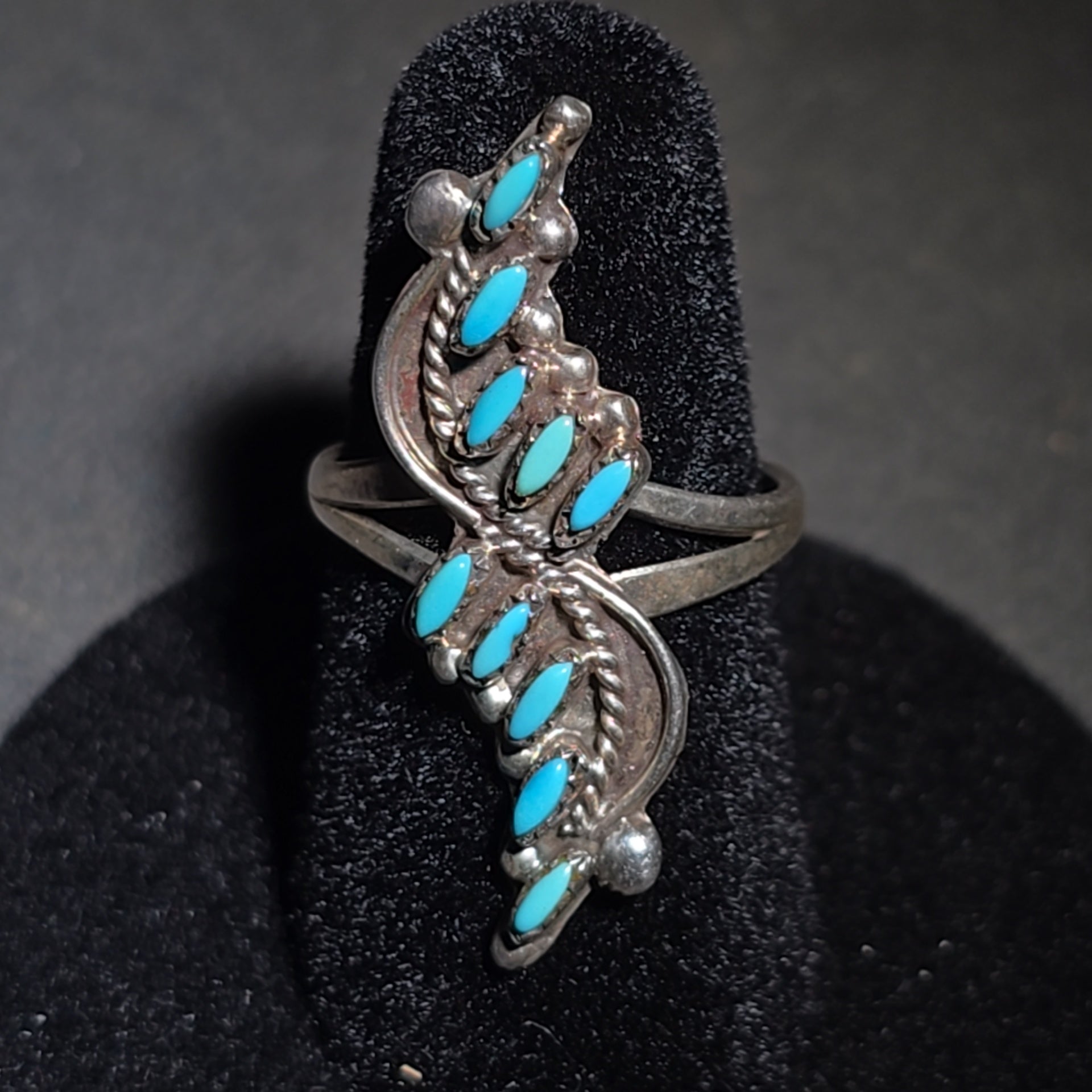Grouping of Four Vintage Southwestern Sterling Silver and Turquoise Rings including Three Matching Petit Point Leaf Rings and a Three-Stone Oval Cabochon Ring
