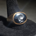 Lot 024 - 10k Gold Ring with Oval Intaglio-Carved Dark Stone Depicting a Roman Warrior in Plumed Helmet and Crosshatch Textured Band, Size 10.5, Total Weight 9.19 g