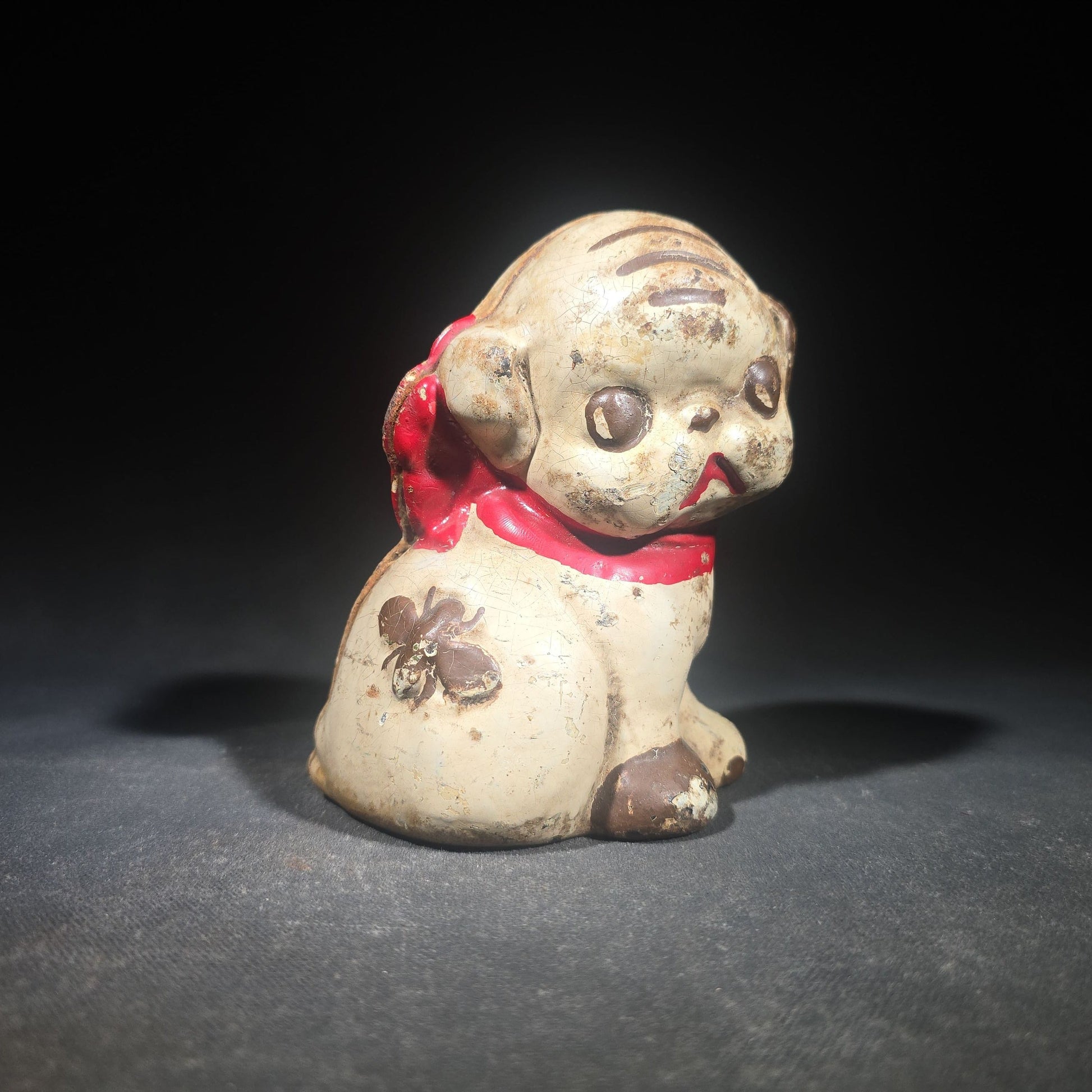 Vintage Hubley "Puppo" Painted Cast Iron Figural Puppy Still Bank with Red Bow and Bee Motif