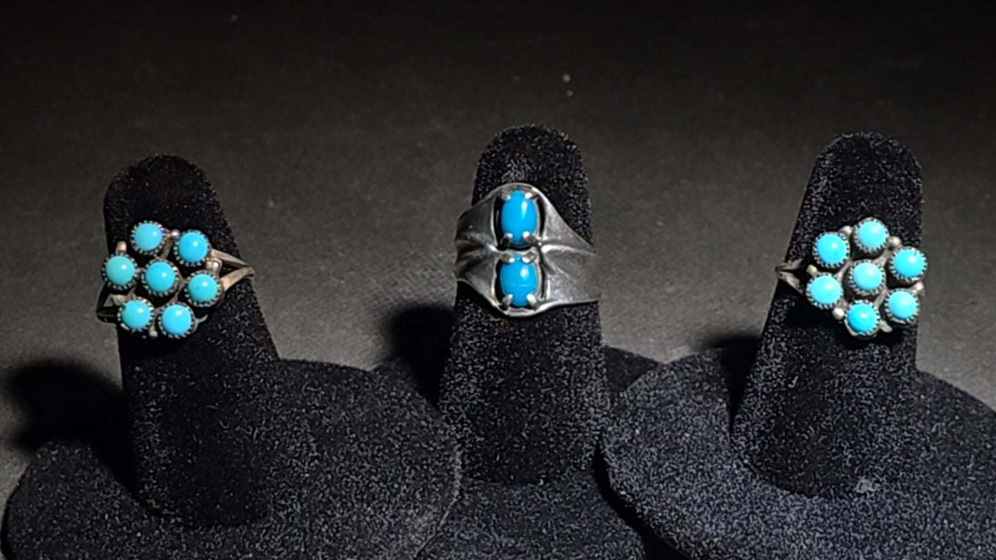 Trio of Vintage Southwestern Sterling Silver and Turquoise Rings Including Two Matching Seven-Stone Cluster Flower Rings and a Two-Stone Oval Cabochon Ring