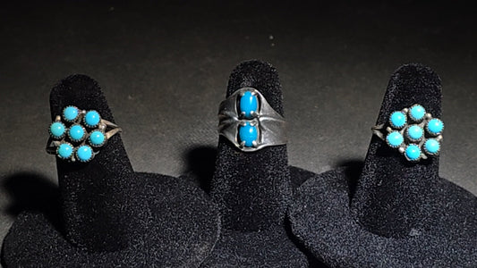 Trio of Vintage Southwestern Sterling Silver and Turquoise Rings Including Two Matching Seven-Stone Cluster Flower Rings and a Two-Stone Oval Cabochon Ring