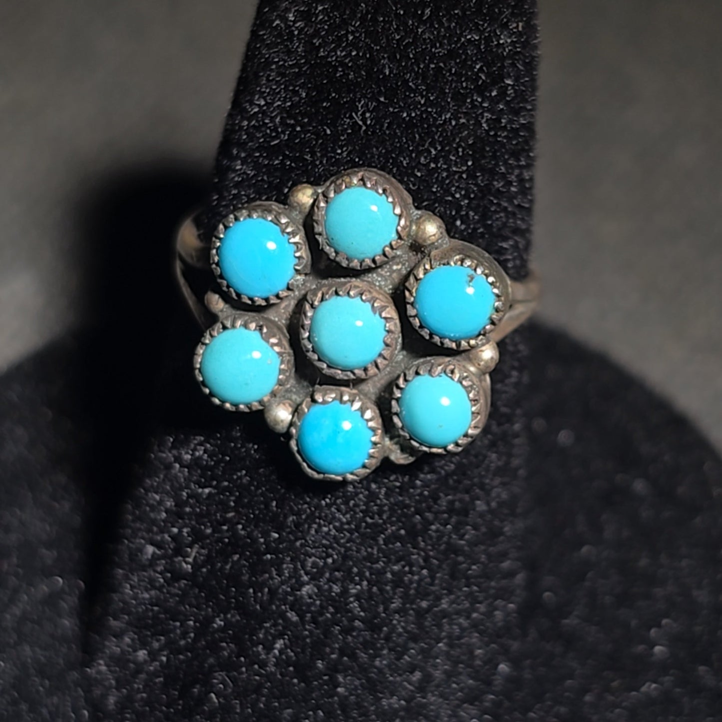 Trio of Vintage Southwestern Sterling Silver and Turquoise Rings Including Two Matching Seven-Stone Cluster Flower Rings and a Two-Stone Oval Cabochon Ring