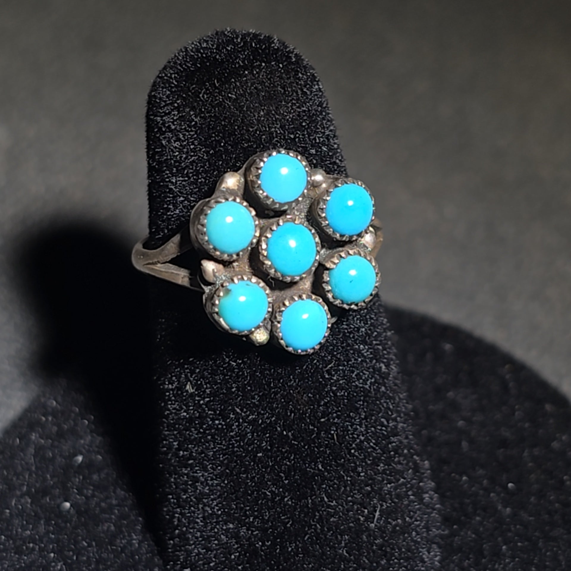 Trio of Vintage Southwestern Sterling Silver and Turquoise Rings Including Two Matching Seven-Stone Cluster Flower Rings and a Two-Stone Oval Cabochon Ring