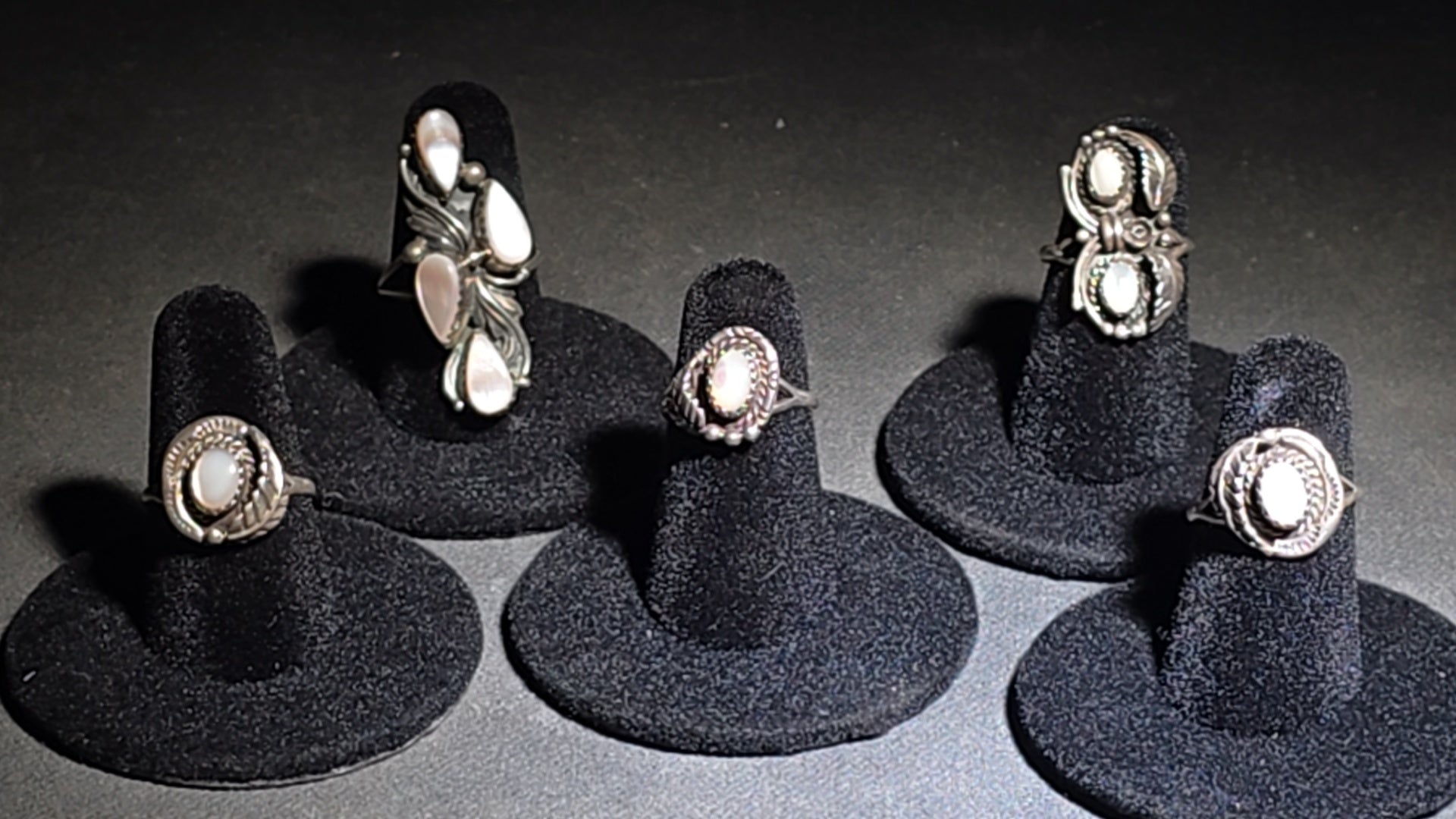 Grouping of Five Vintage Navajo Silver and Mother of Pearl Rings including a Four-Stone Ring by Les Hill, Sizes four through Seven