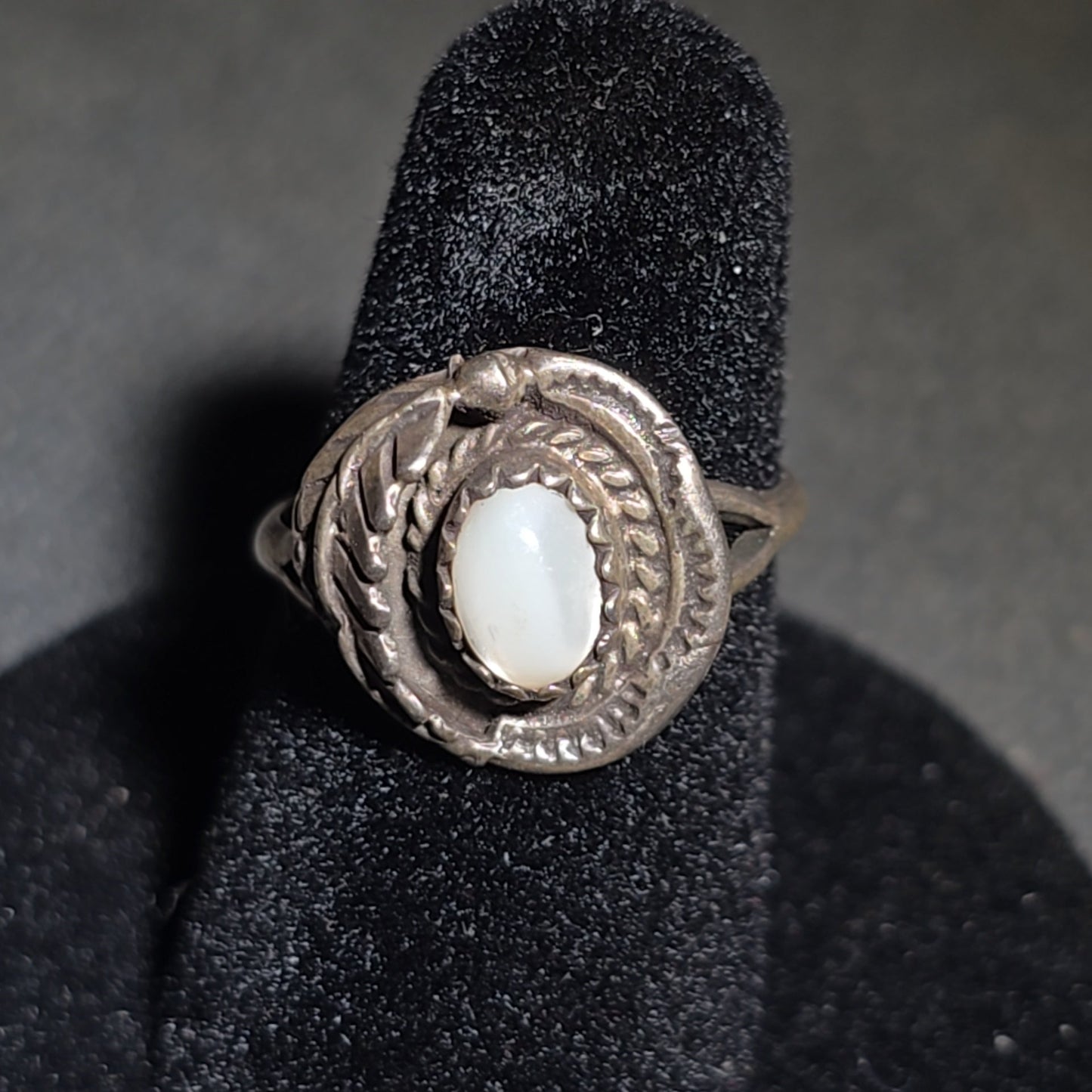 Grouping of Five Vintage Navajo Silver and Mother of Pearl Rings including a Four-Stone Ring by Les Hill, Sizes four through Seven