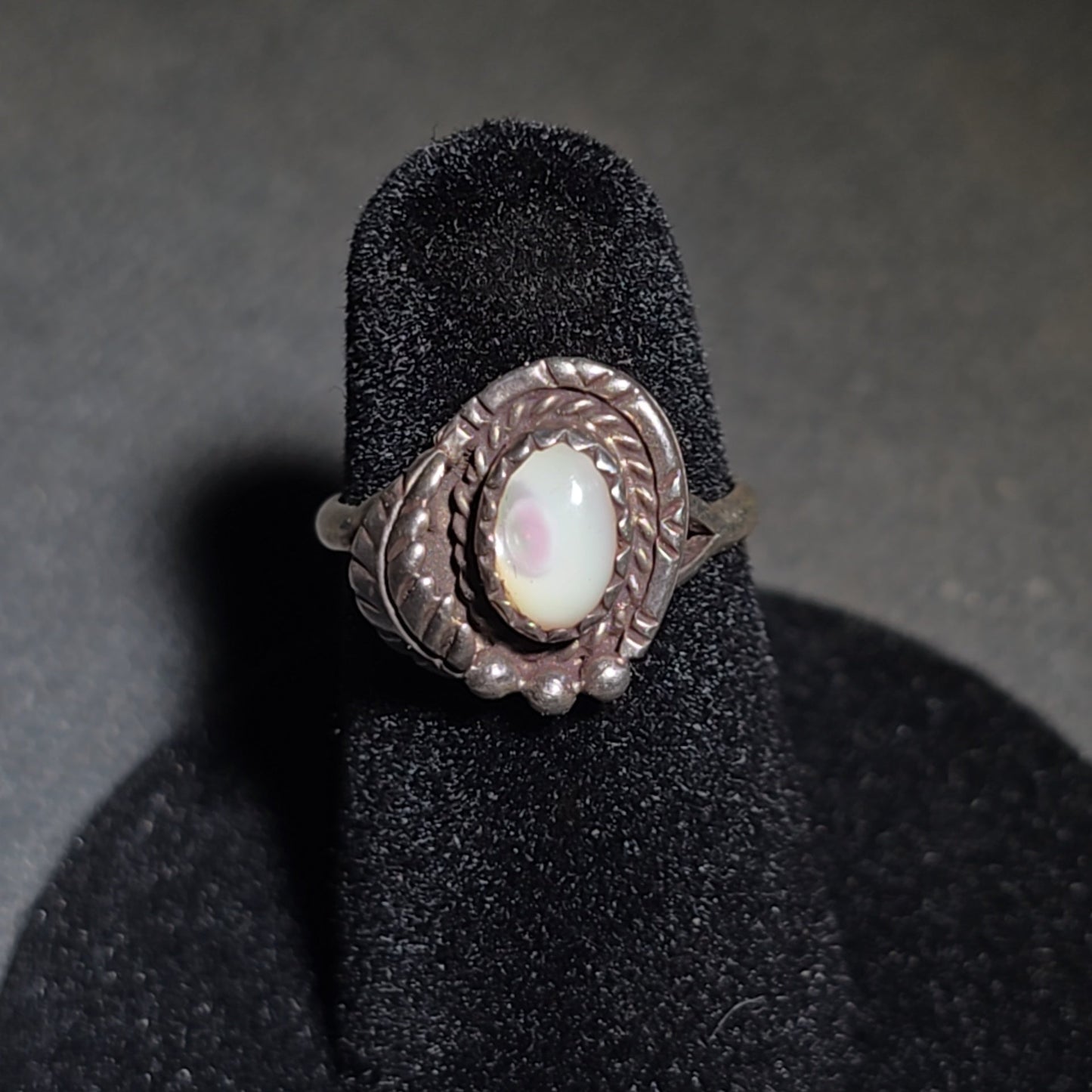 Grouping of Five Vintage Navajo Silver and Mother of Pearl Rings including a Four-Stone Ring by Les Hill, Sizes four through Seven