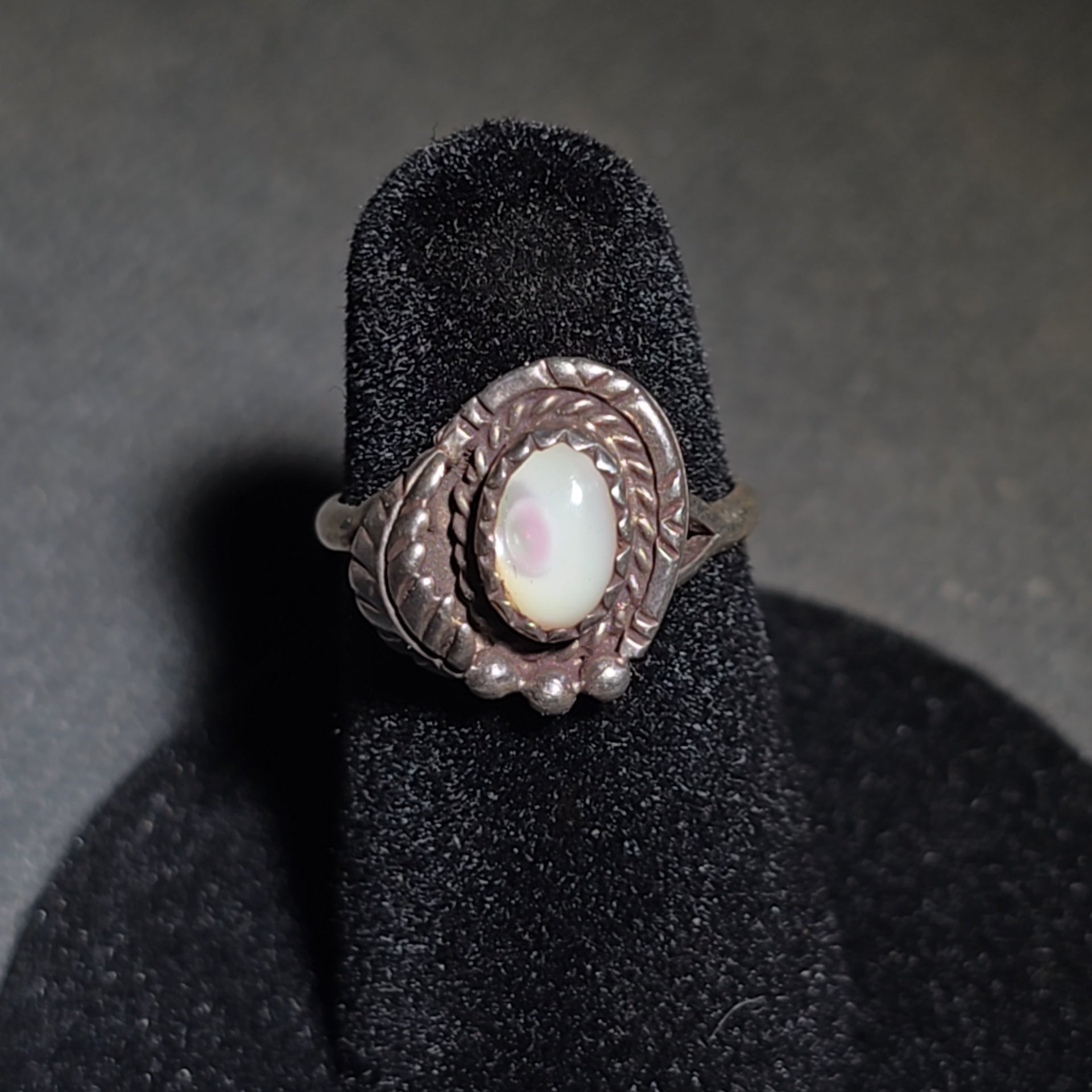 Grouping of Five Vintage Navajo Silver and Mother of Pearl Rings including a Four-Stone Ring by Les Hill, Sizes four through Seven