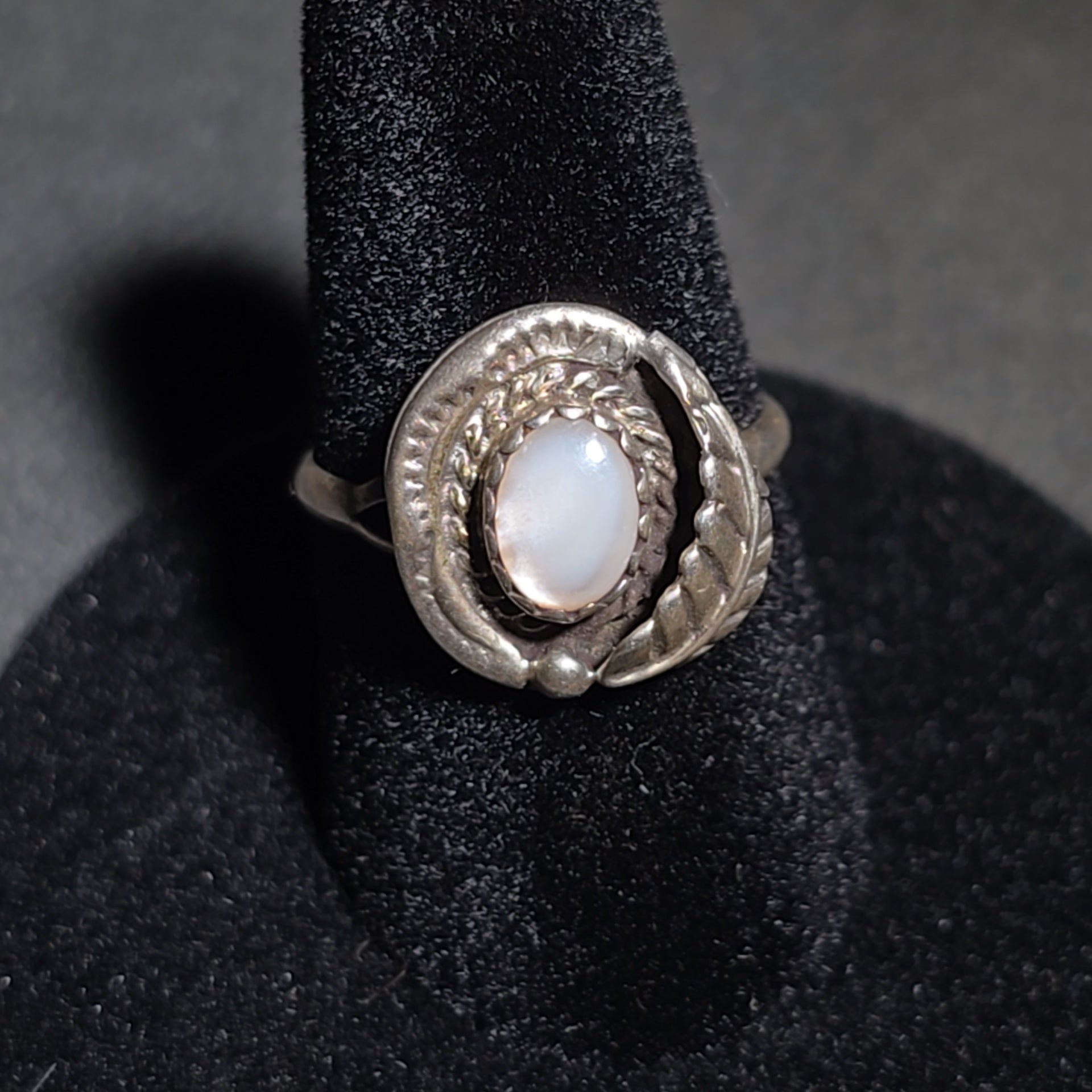 Grouping of Five Vintage Navajo Silver and Mother of Pearl Rings including a Four-Stone Ring by Les Hill, Sizes four through Seven