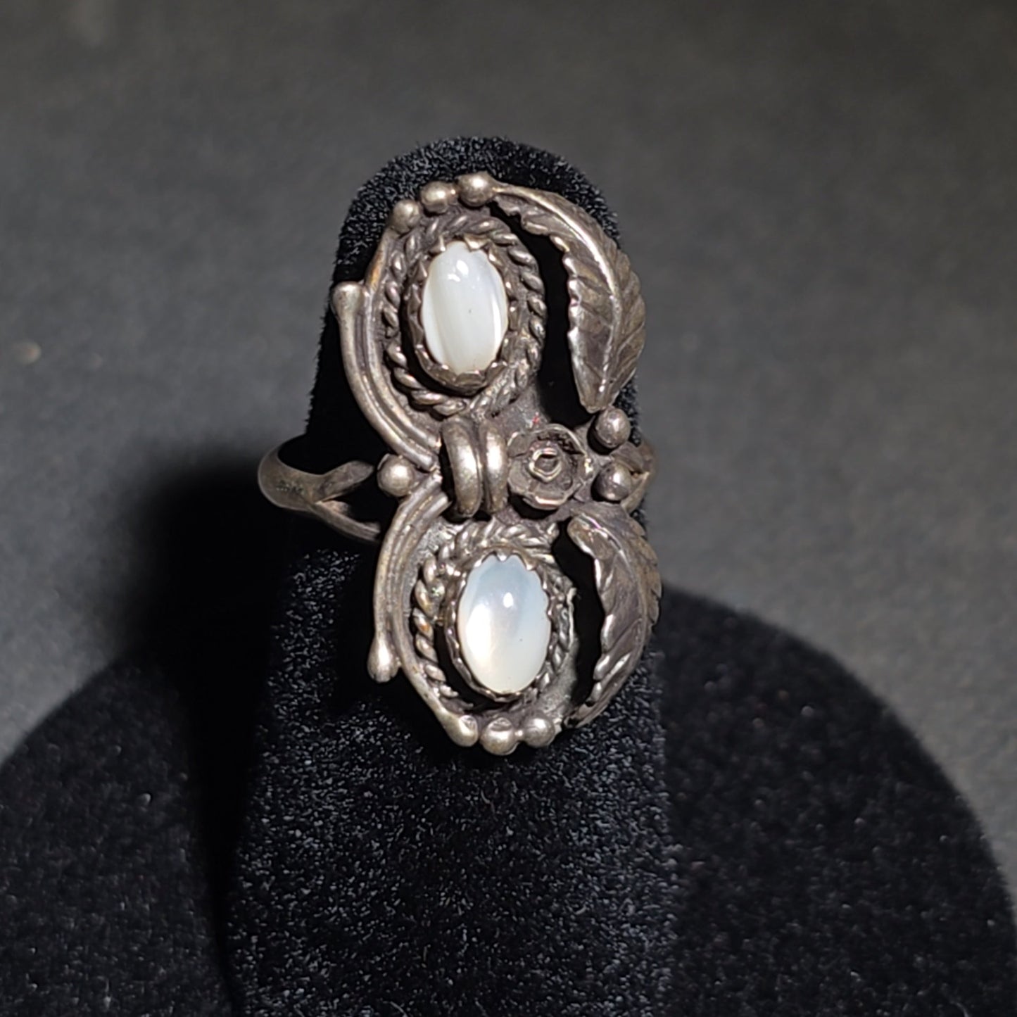 Grouping of Five Vintage Navajo Silver and Mother of Pearl Rings including a Four-Stone Ring by Les Hill, Sizes four through Seven