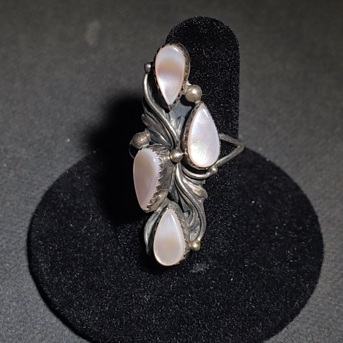 Grouping of Five Vintage Navajo Silver and Mother of Pearl Rings including a Four-Stone Ring by Les Hill, Sizes four through Seven