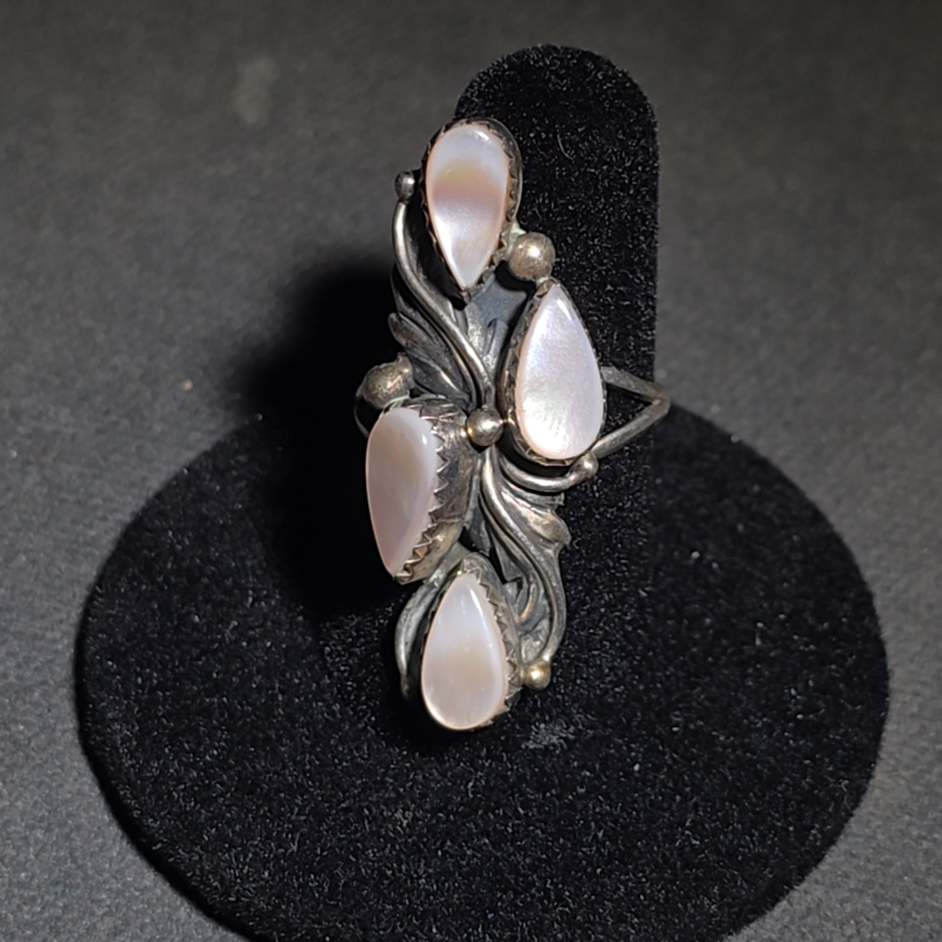 Grouping of Five Vintage Navajo Silver and Mother of Pearl Rings including a Four-Stone Ring by Les Hill, Sizes four through Seven