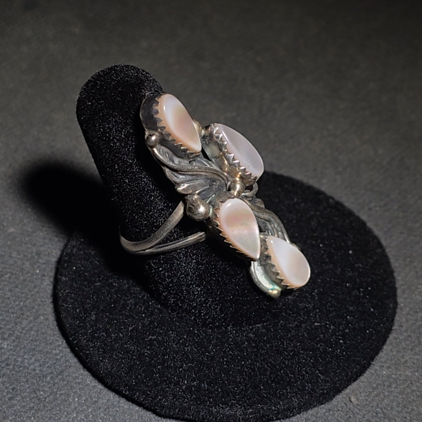 Grouping of Five Vintage Navajo Silver and Mother of Pearl Rings including a Four-Stone Ring by Les Hill, Sizes four through Seven