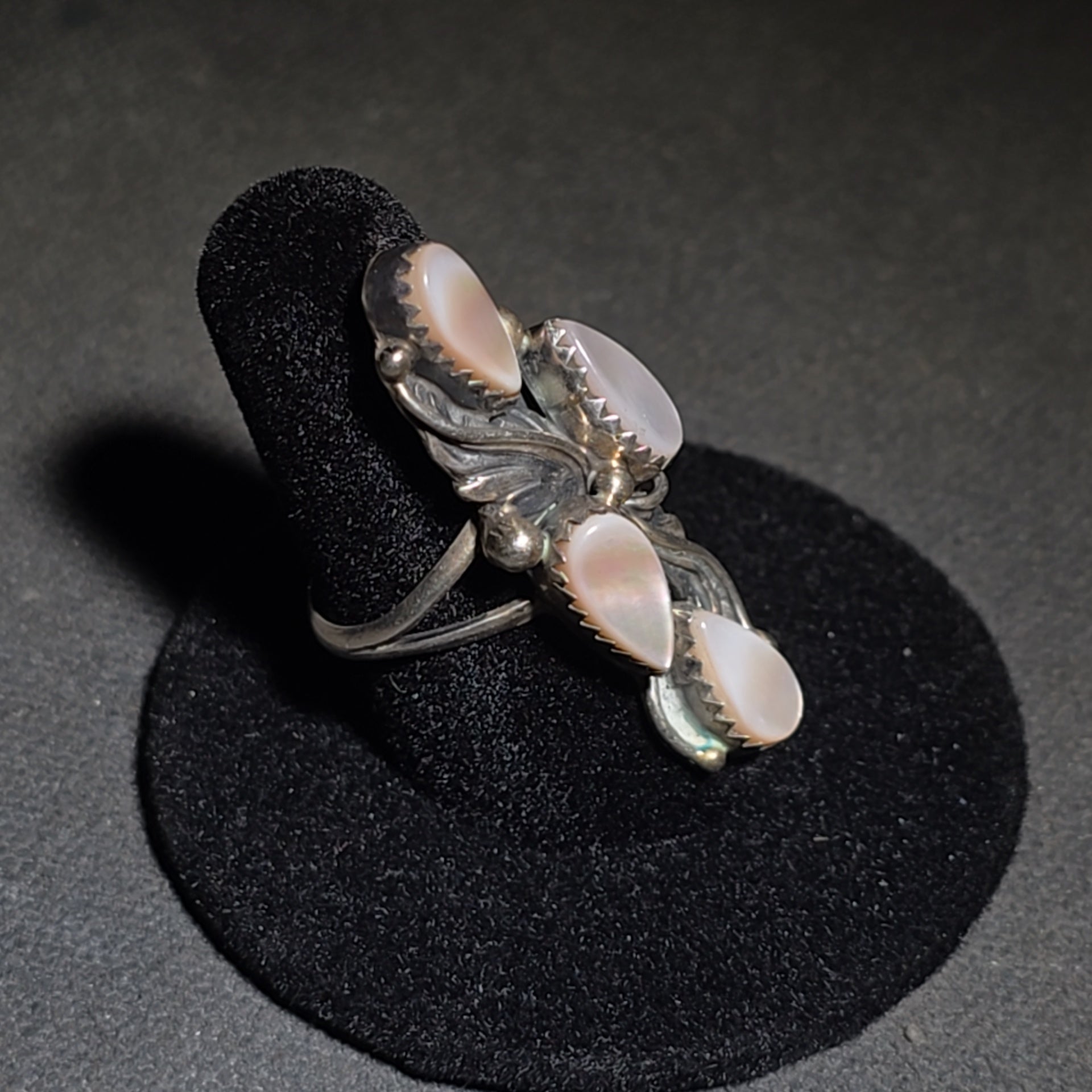 Grouping of Five Vintage Navajo Silver and Mother of Pearl Rings including a Four-Stone Ring by Les Hill, Sizes four through Seven