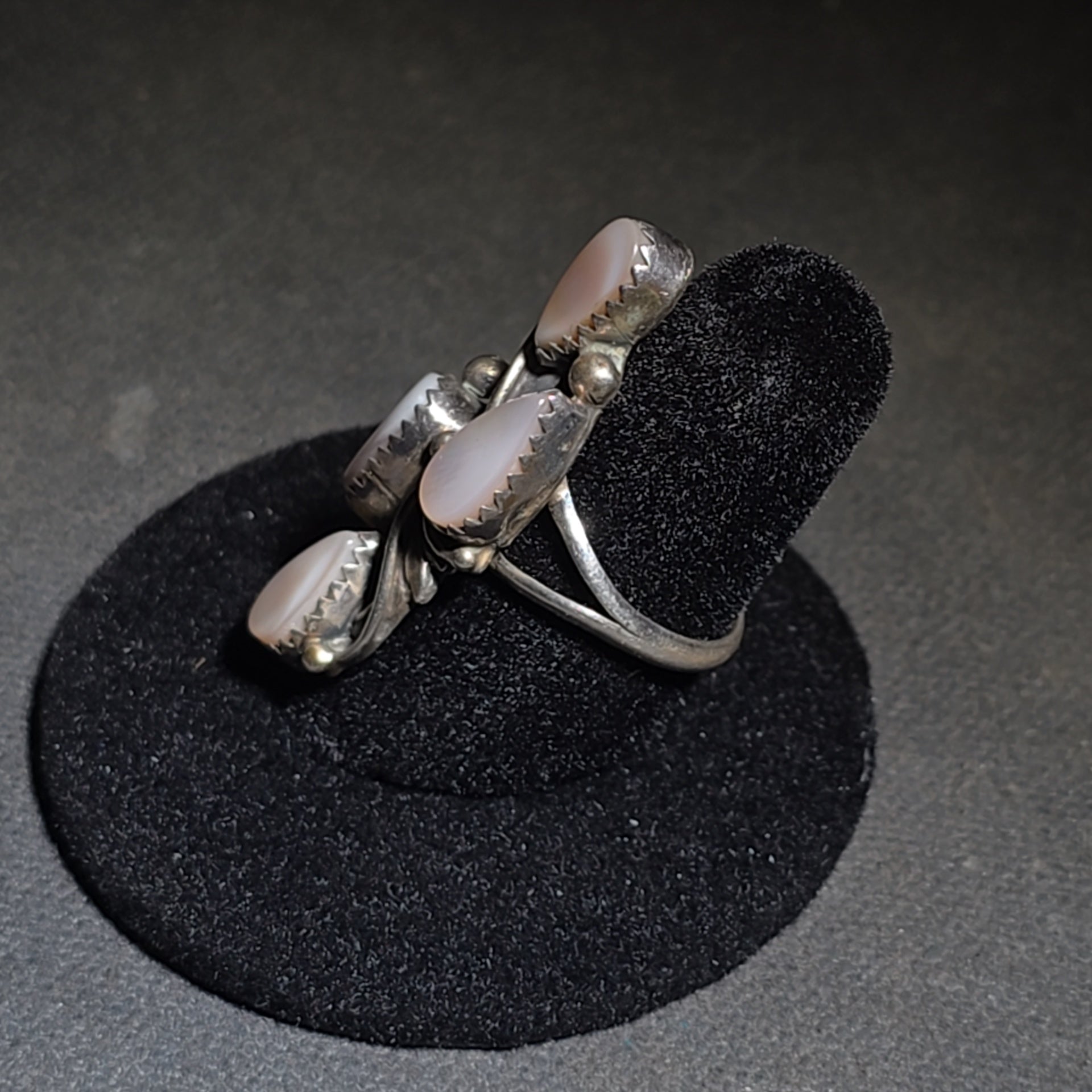 Grouping of Five Vintage Navajo Silver and Mother of Pearl Rings including a Four-Stone Ring by Les Hill, Sizes four through Seven