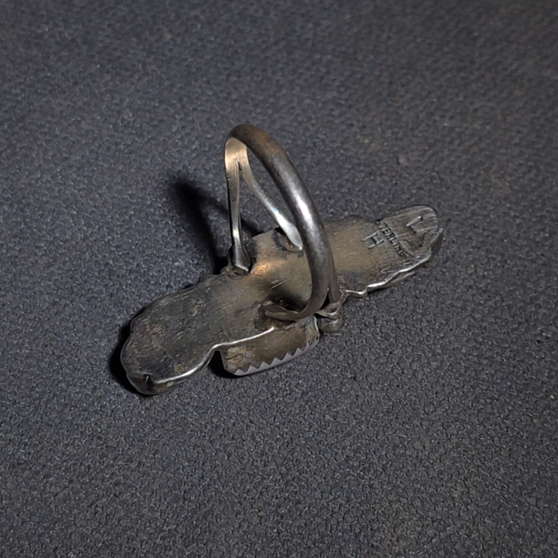 Grouping of Five Vintage Navajo Silver and Mother of Pearl Rings including a Four-Stone Ring by Les Hill, Sizes four through Seven
