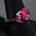 Lot 031 - 10k Gold Ruby and Diamond Bypass Ring with Oval Center Stone and Baguette Ruby Accents, Unmarked, Size 6.5, Total Weight 2.23 g