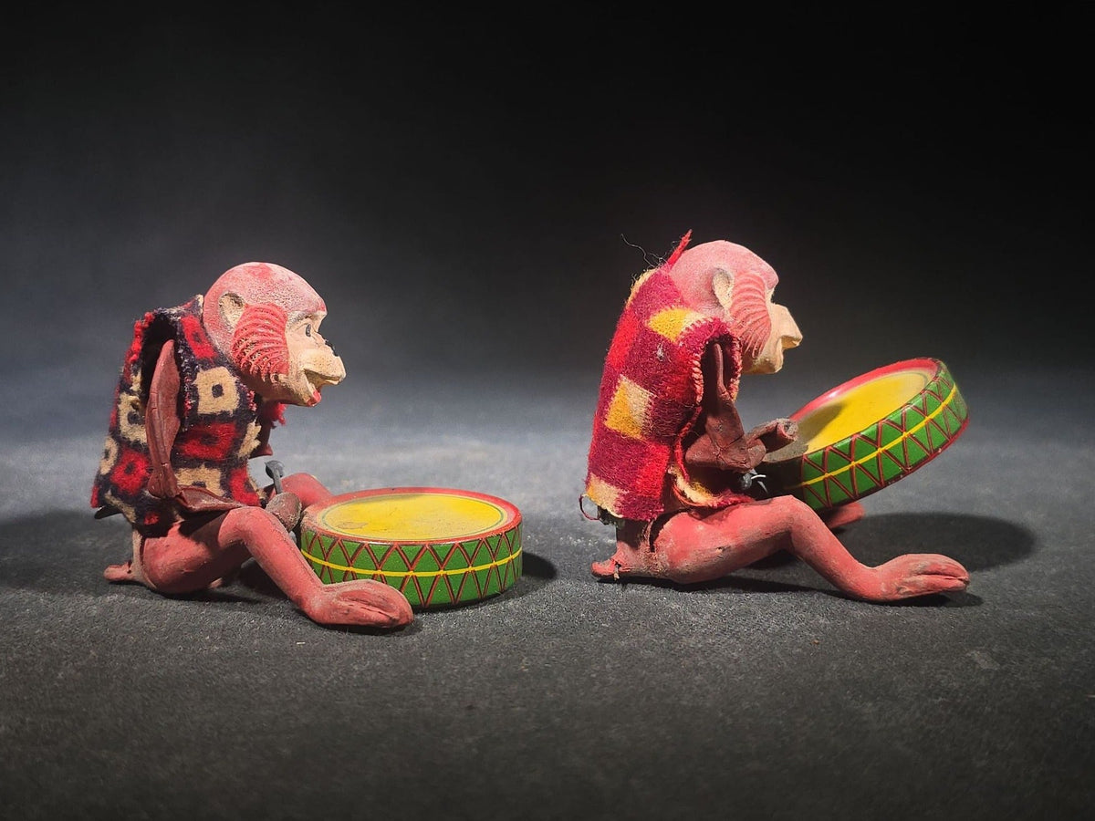 Pair of Vintage Rubber and Tin Lithograph Drumming Monkey Toys with Fabric Jackets, Note Missing Arm, Splits in Rubber