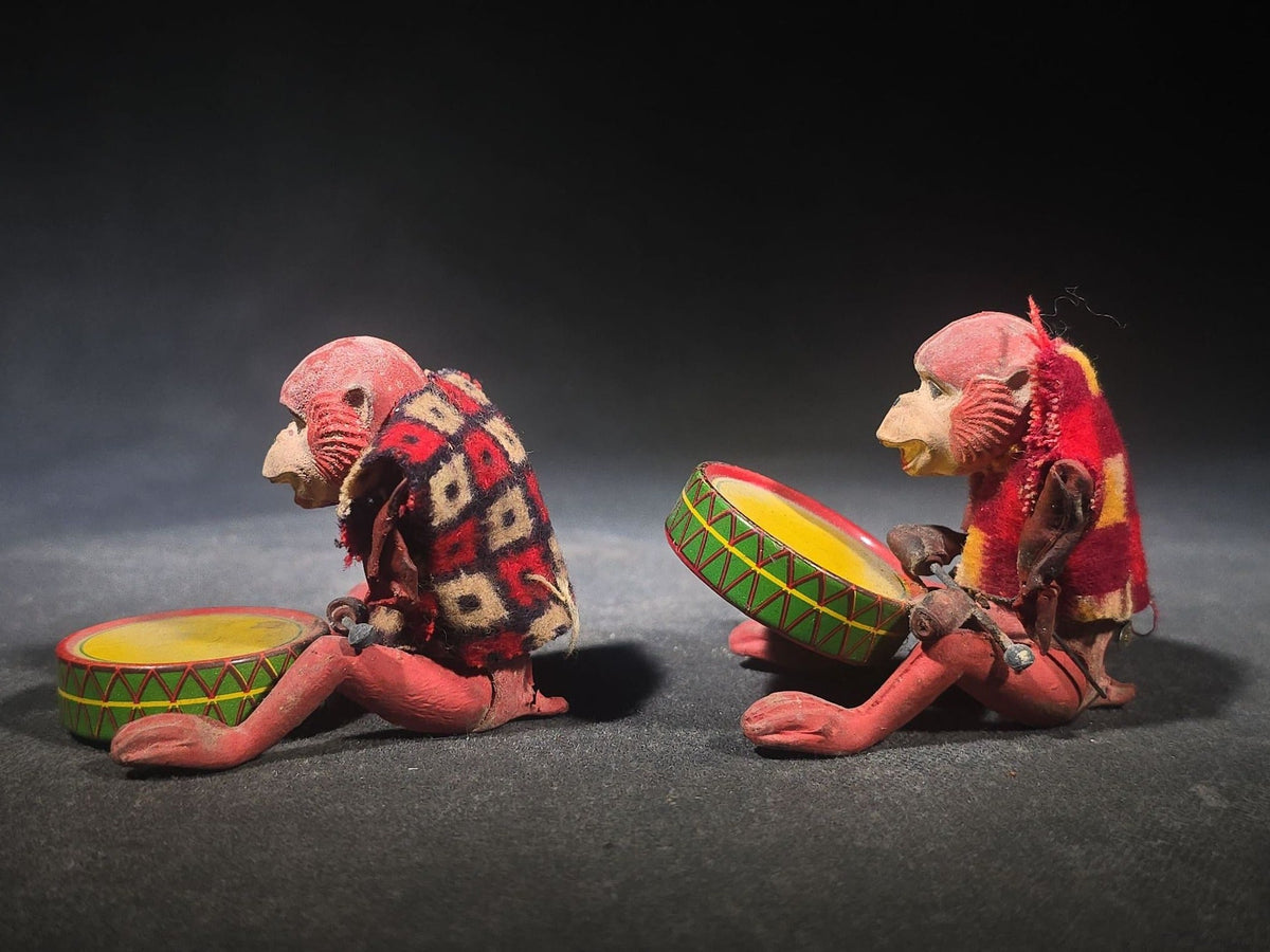Pair of Vintage Rubber and Tin Lithograph Drumming Monkey Toys with Fabric Jackets, Note Missing Arm, Splits in Rubber