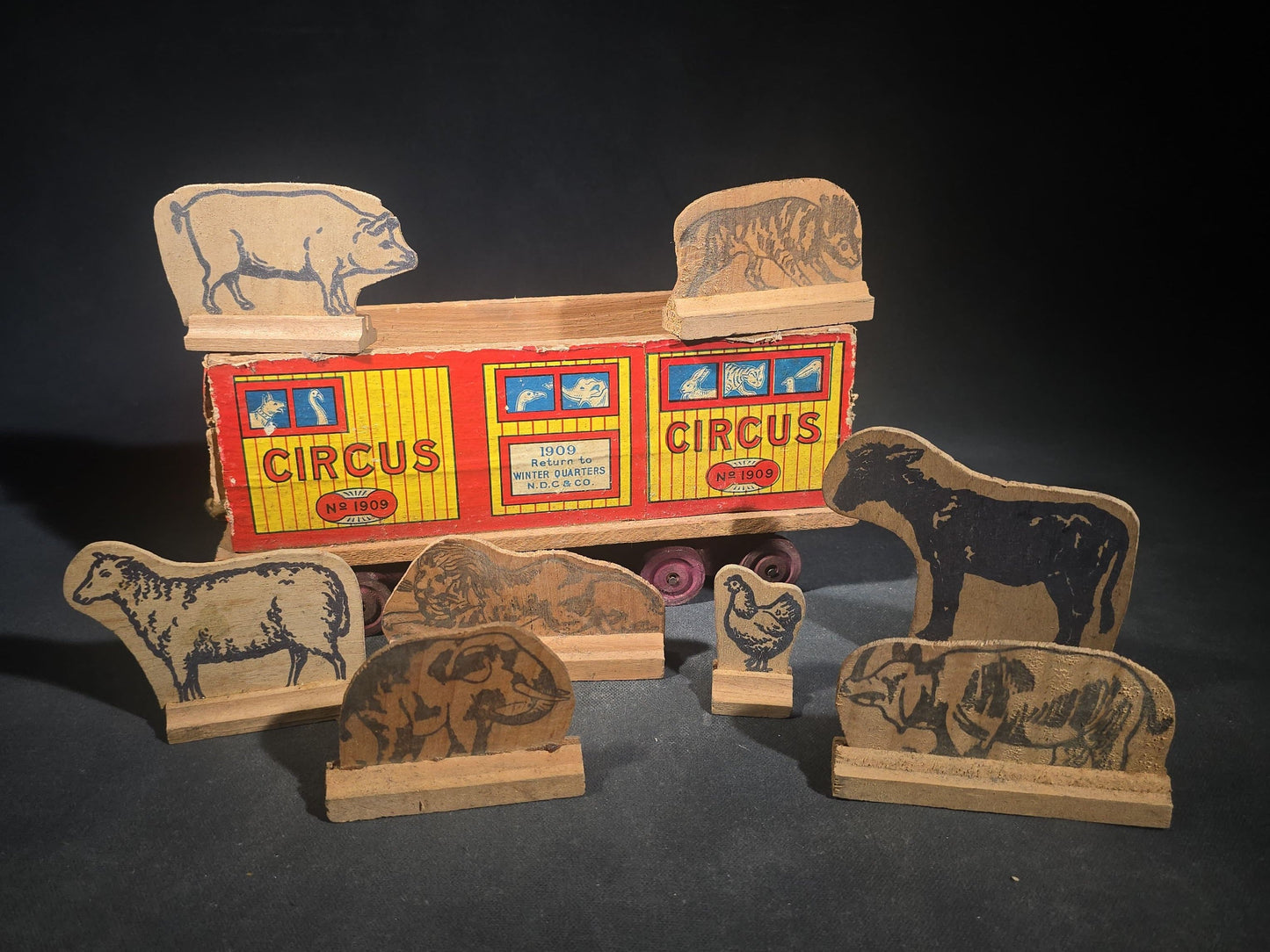Antique N.D.C. & Co. Wooden Circus Car No. 1909 Pull Toy with Paper Lithograph Graphics and Eight Wooden Animal Figures, Note Missing One Wheel