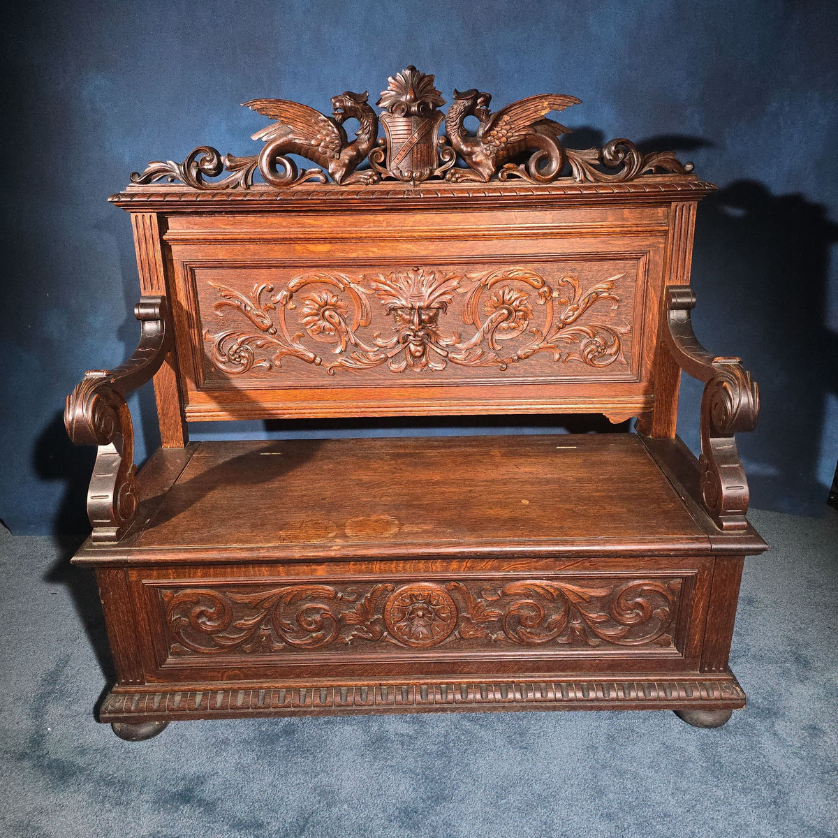 Antique Renaissance Revival Carved Oak Hall Bench with Lift-Top Storage, Green Man, Griffin and Shield Crest
