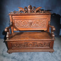 Lot 003 - Antique Renaissance Revival Carved Oak Hall Bench with Lift-Top Storage, Green Man, Griffin and Shield Crest, 50-1/8" L x 49-1/4" H