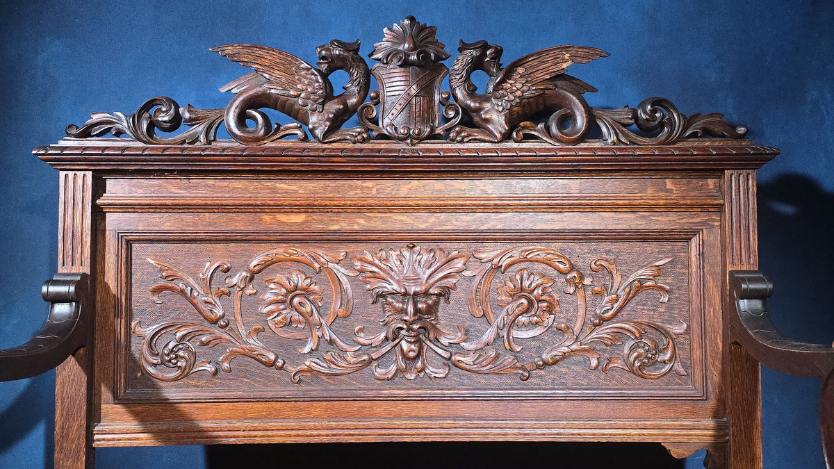 Antique Renaissance Revival Carved Oak Hall Bench with Lift-Top Storage, Green Man, Griffin and Shield Crest